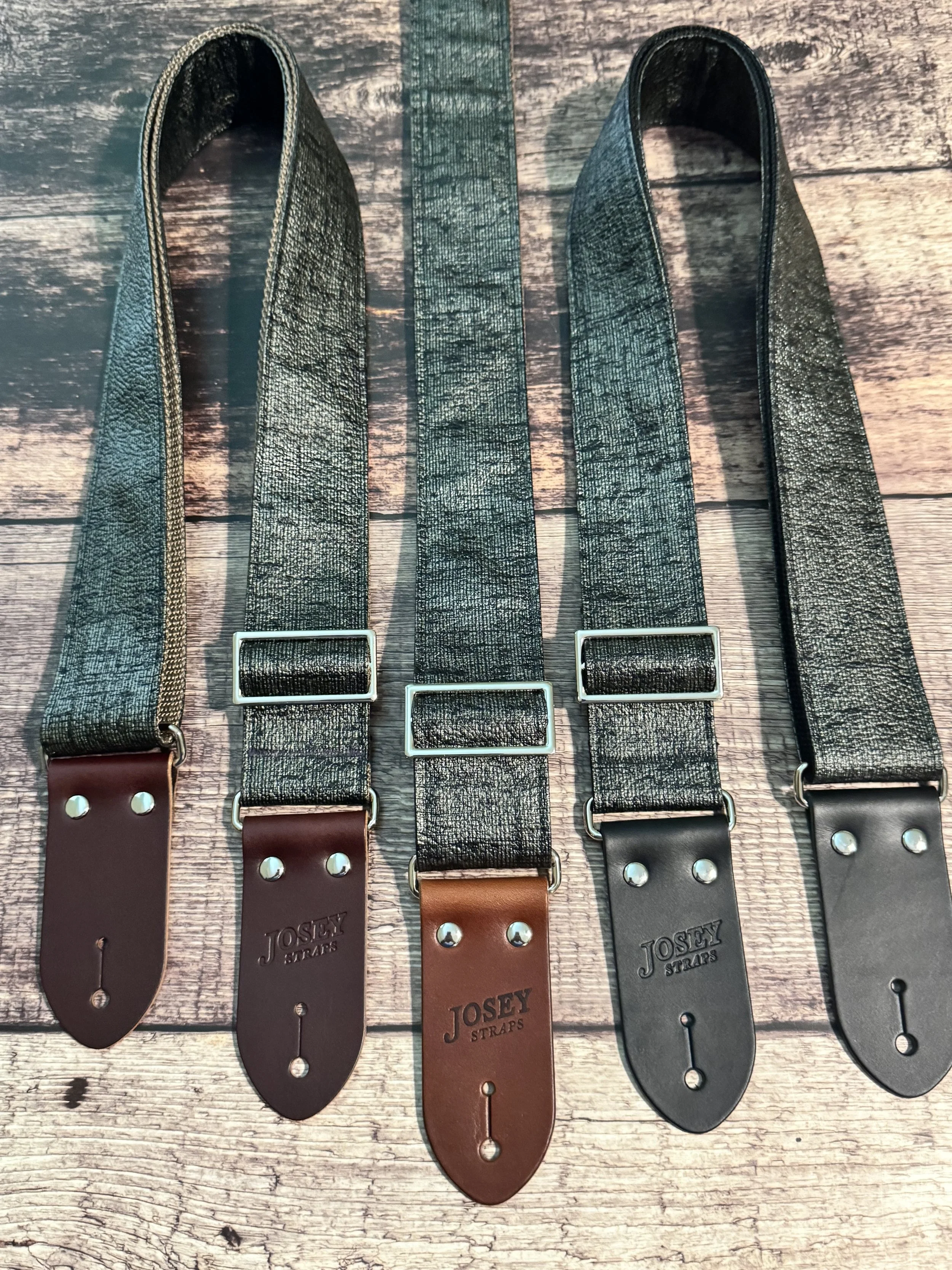Pewter Slub guitar straps on wooden floor.