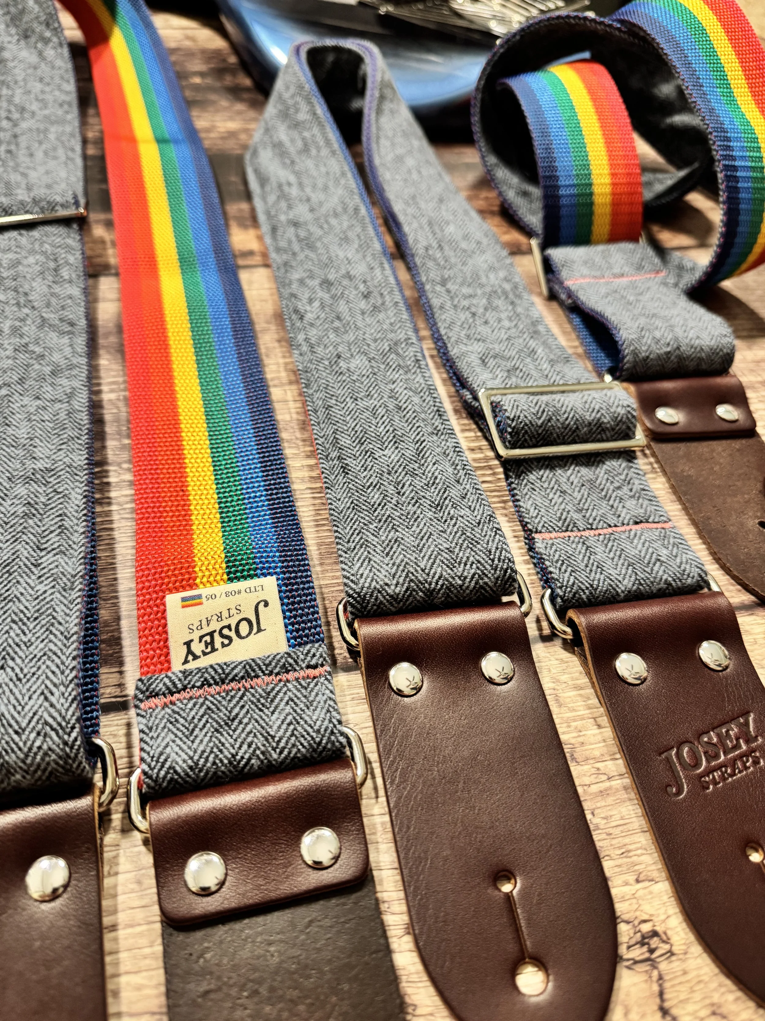 Ally limited-edition guitar strap featuring blue-on-blue herringbone flannel, rainbow backing, and Sunset leather ends by Josey Straps