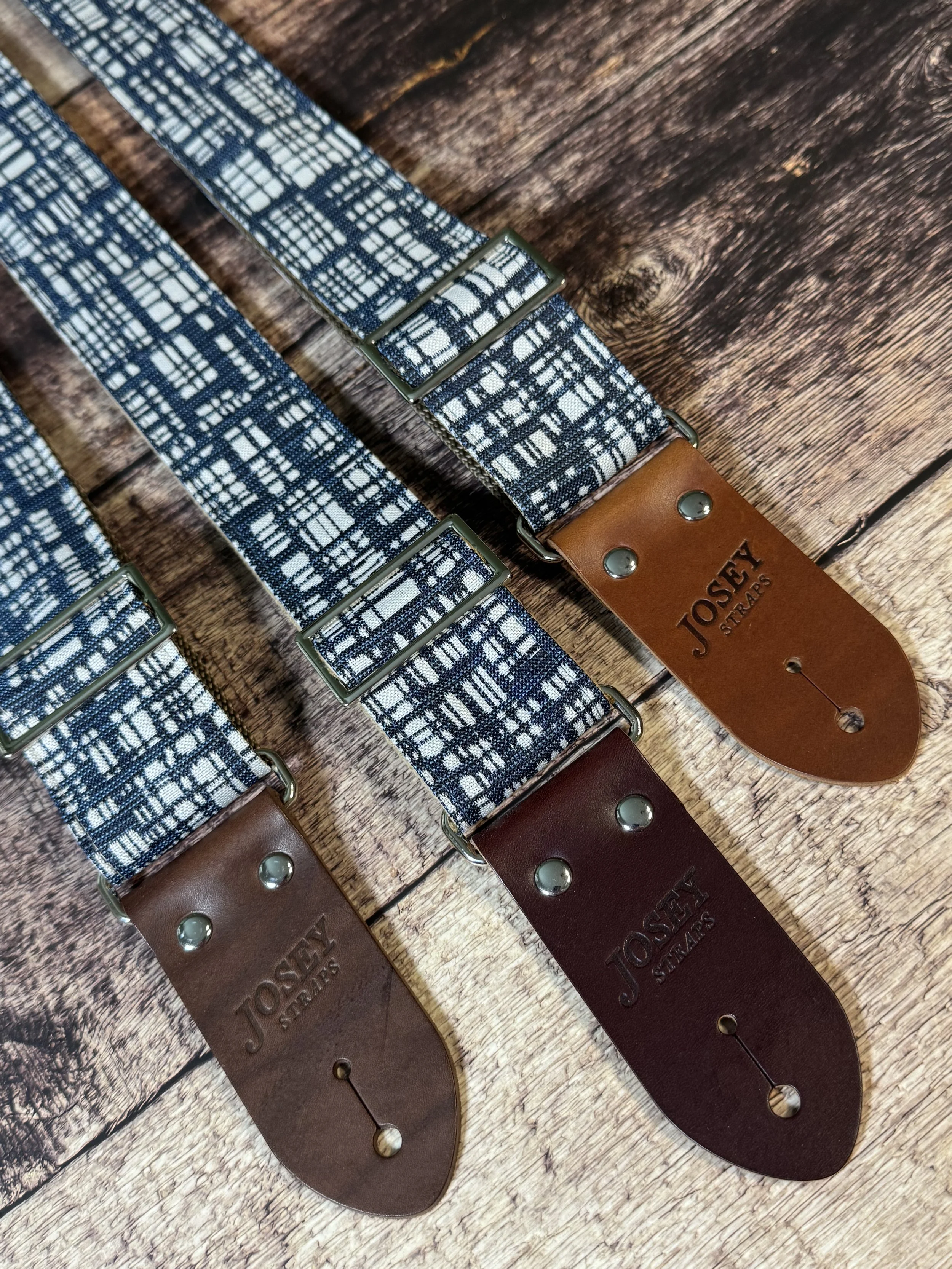 Blueprint guitar strap with blue and white crosshatch pattern and leather ends by Josey Straps.