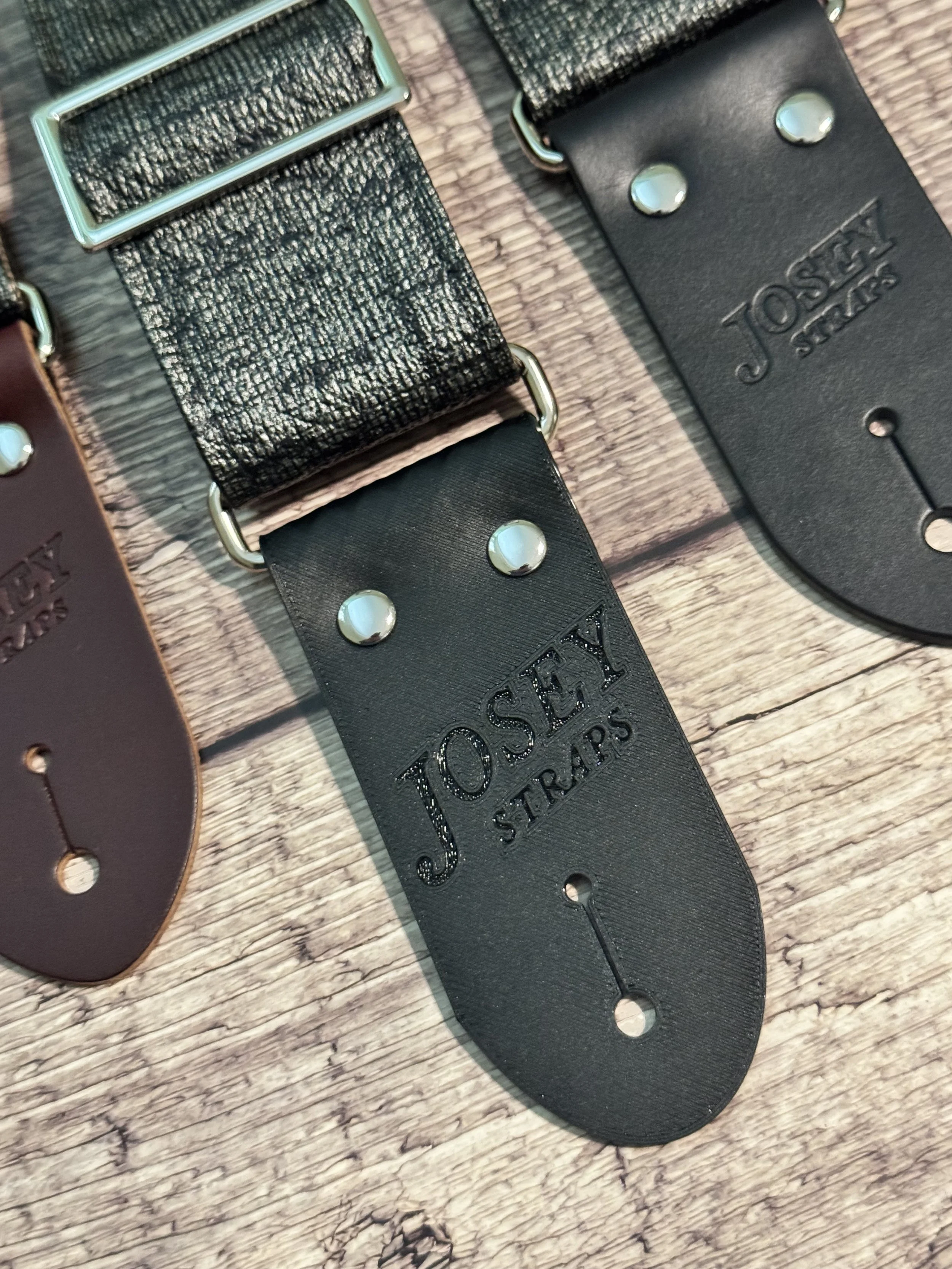 Up close shot of Pewter Slub guitar straps on wooden floor.