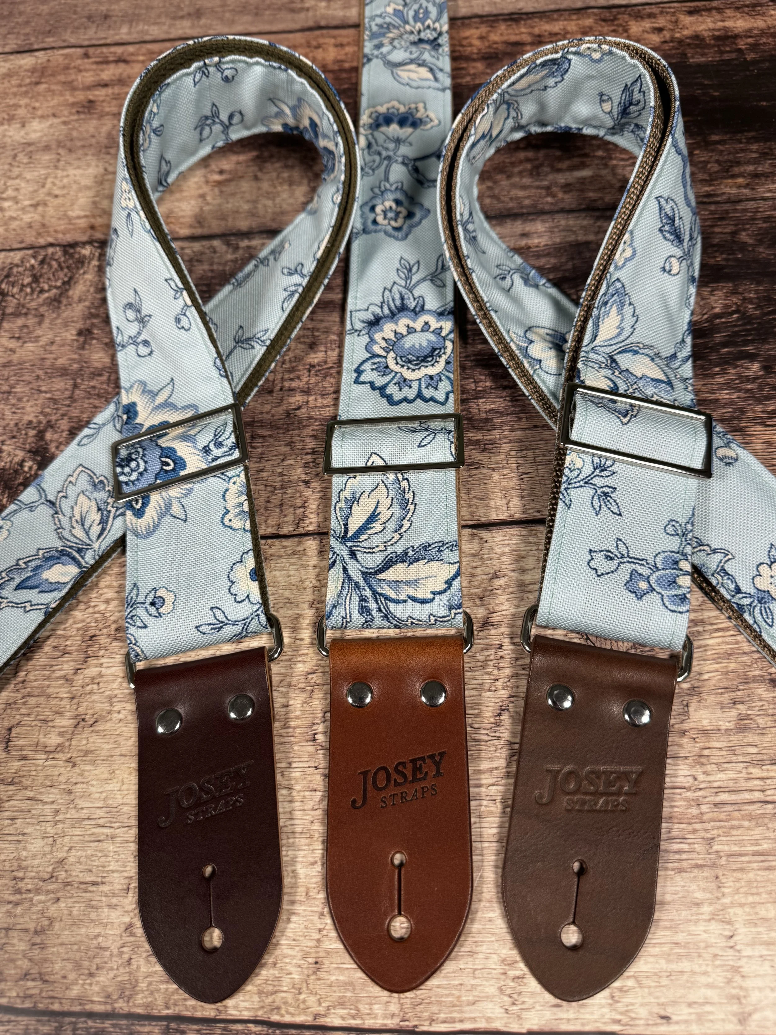 Something Blue floral guitar strap by Josey Straps featuring a powder blue and cream vintage floral pattern with premium leather ends.