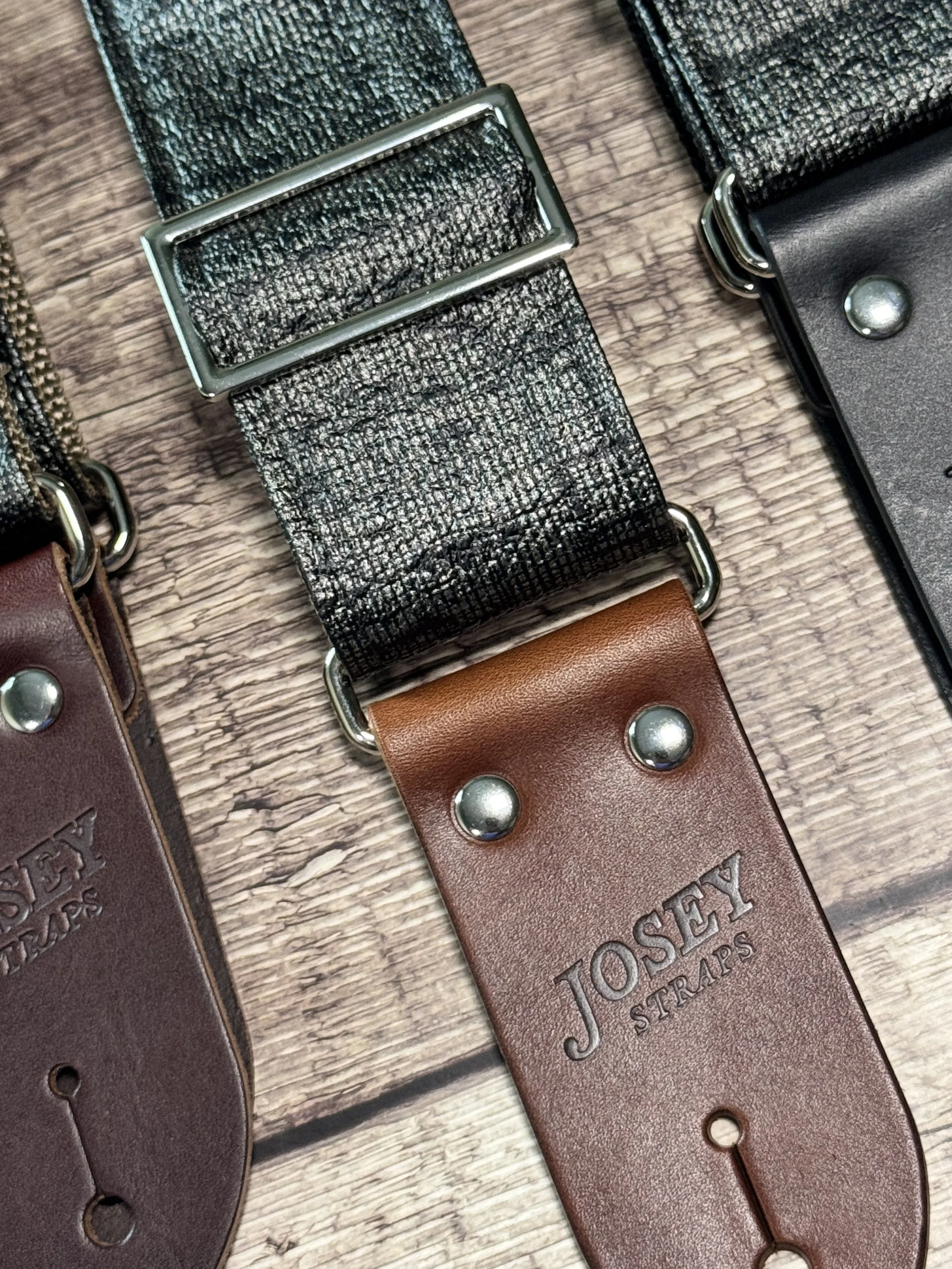 Up close shot of Pewter Slub guitar straps on wooden floor.