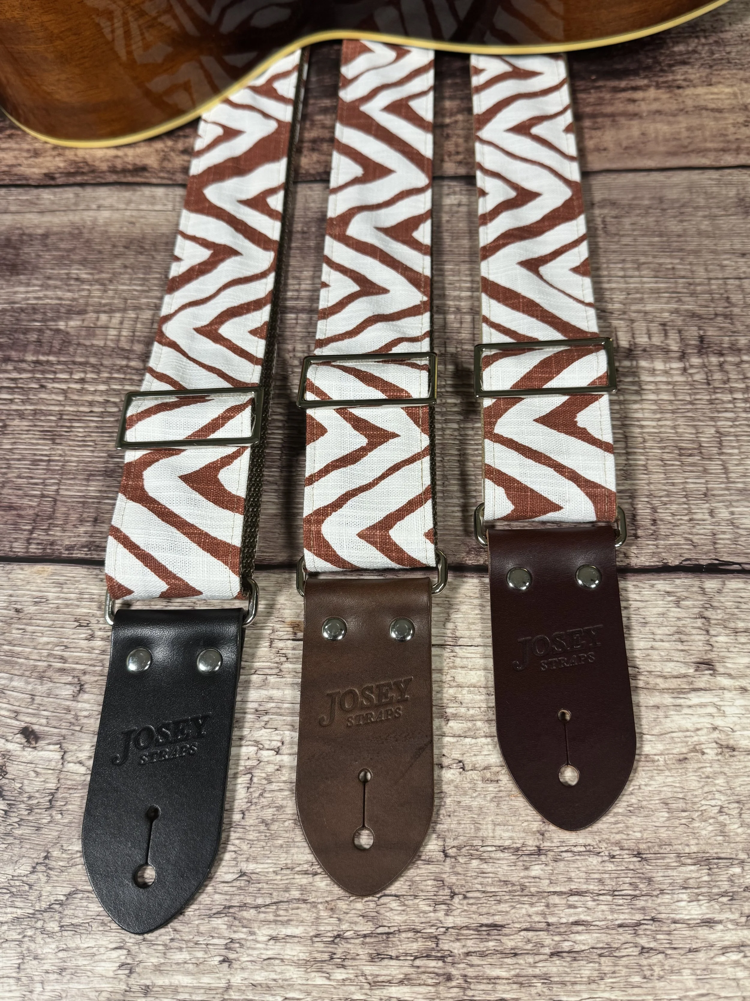 Petroglyph guitar strap featuring an earthy rust and cream geometric pattern by Josey Straps.