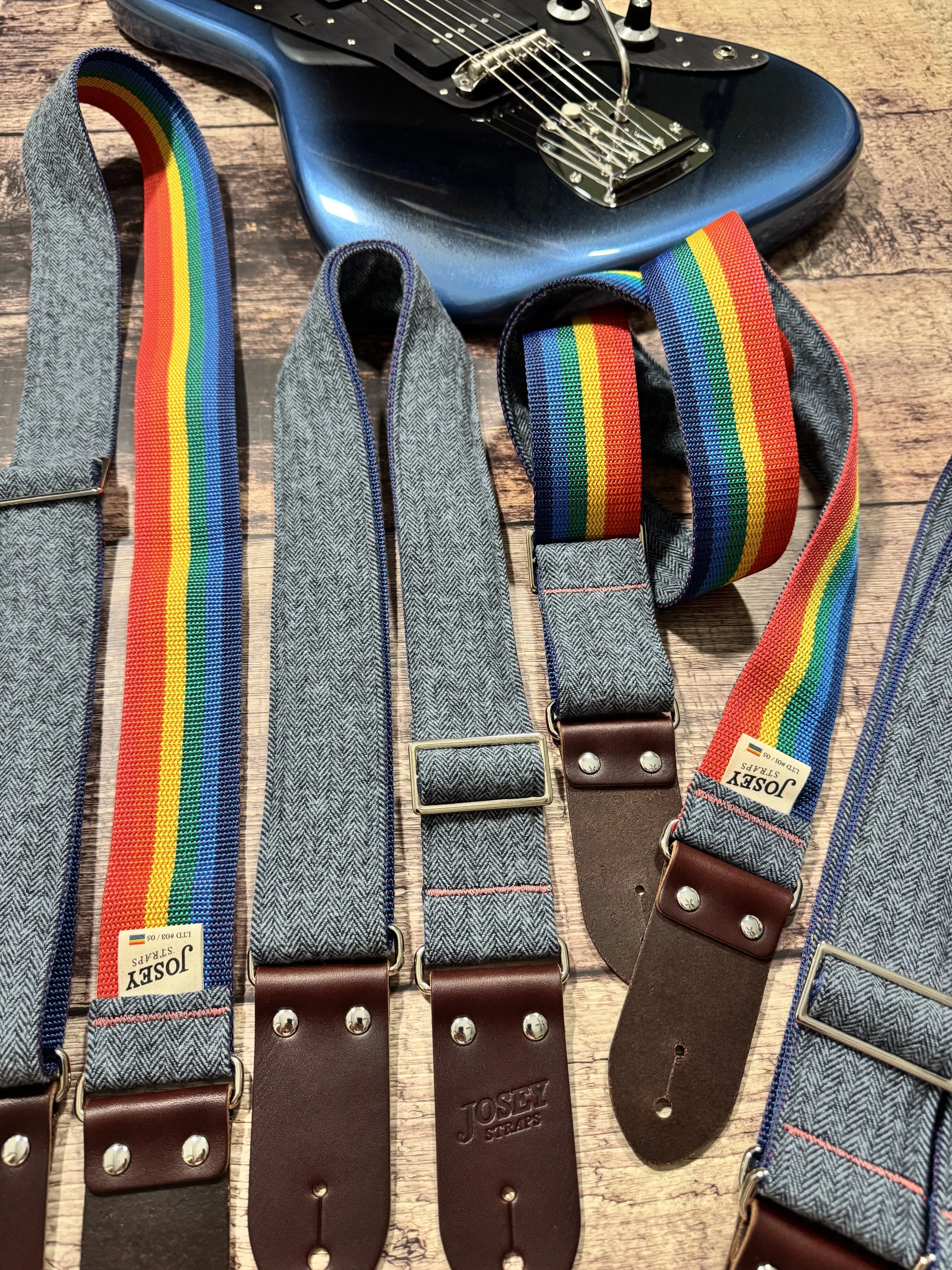 Ally limited-edition guitar strap featuring blue-on-blue herringbone flannel, rainbow backing, and Sunset leather ends by Josey Straps