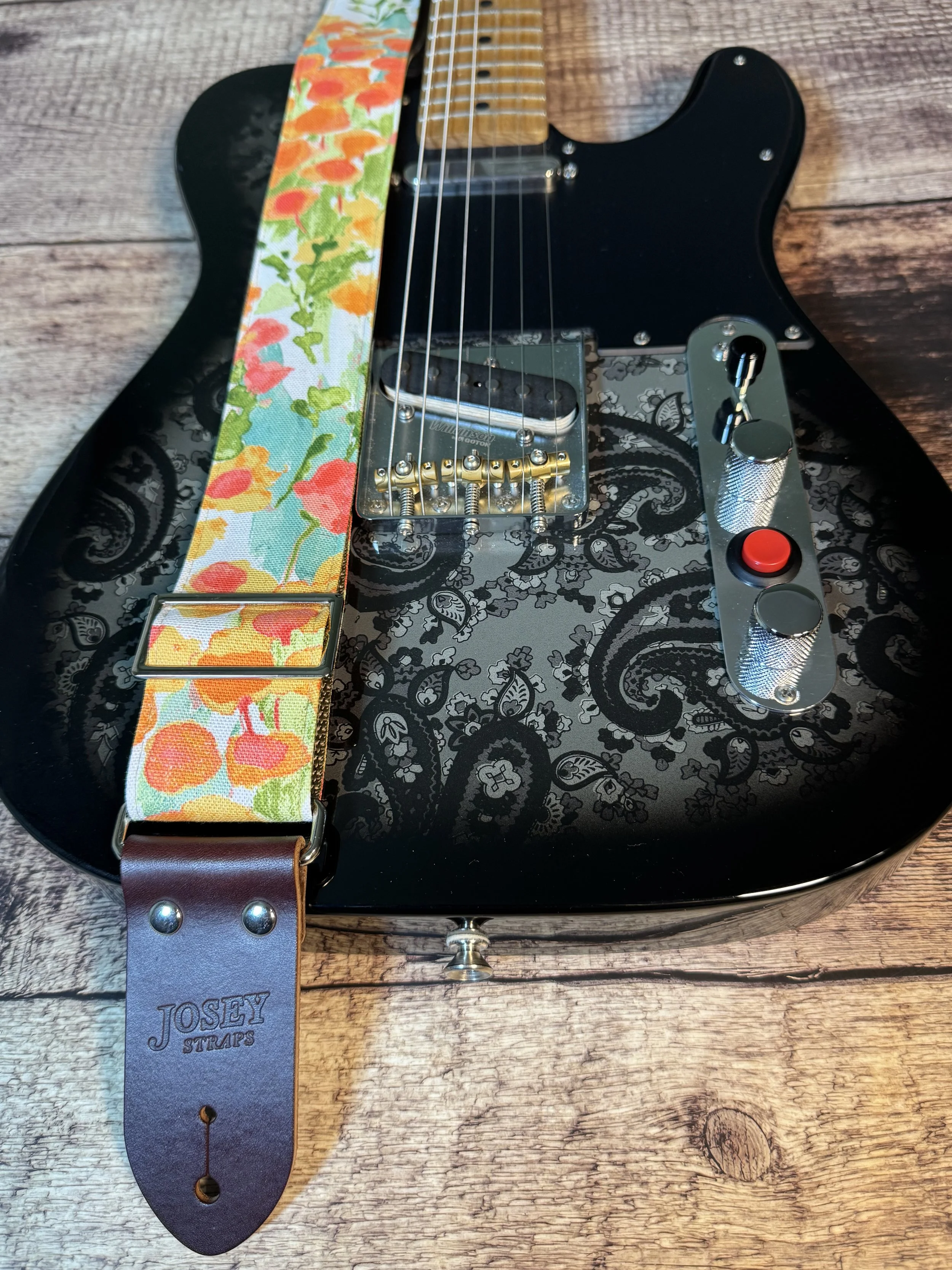 Floral guitar strap with orange, gold, and green flower pattern and leather ends by Josey Straps, In Bloom design