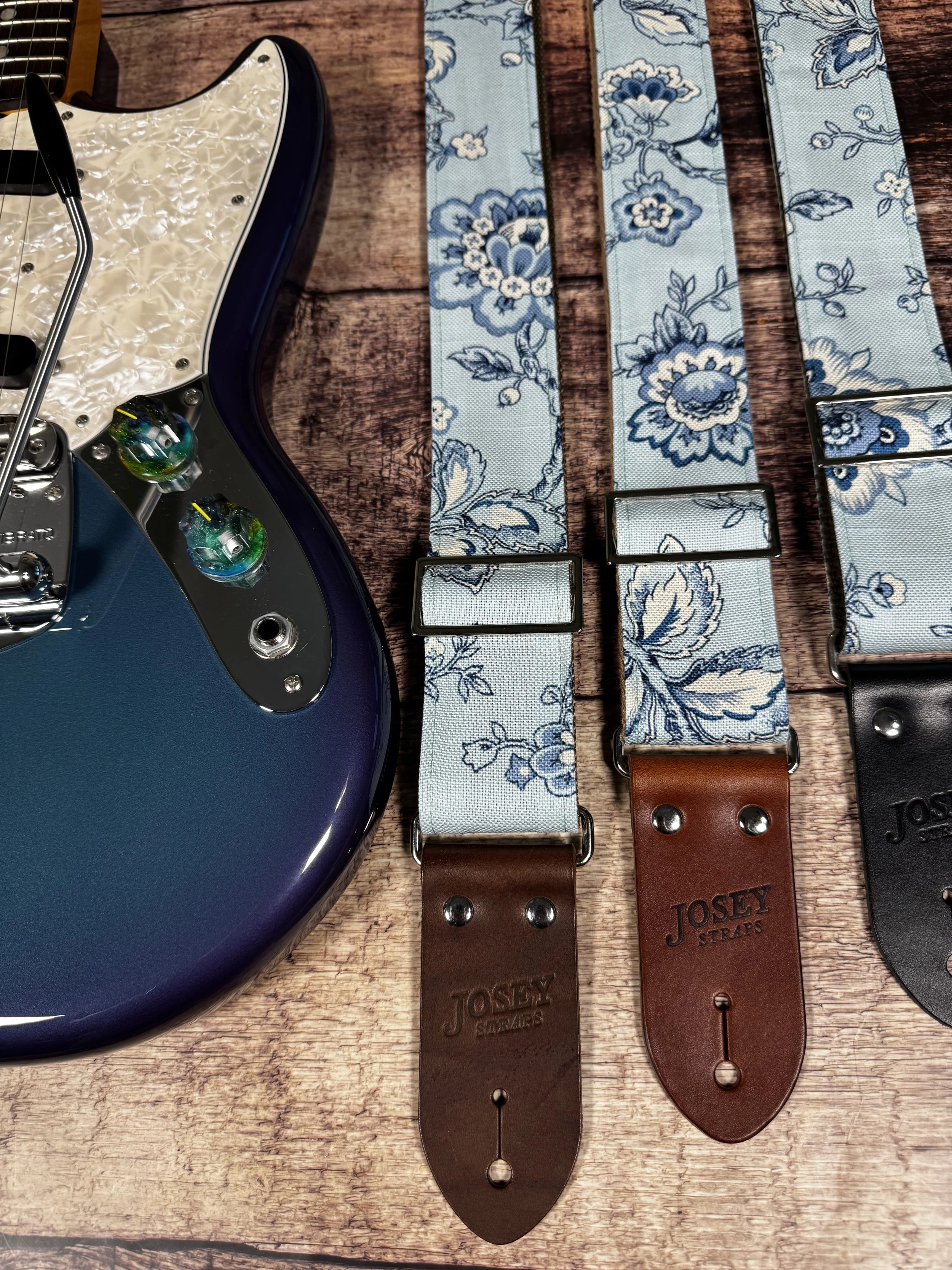 Something Blue floral guitar strap by Josey Straps featuring a powder blue and cream vintage floral pattern with premium leather ends.