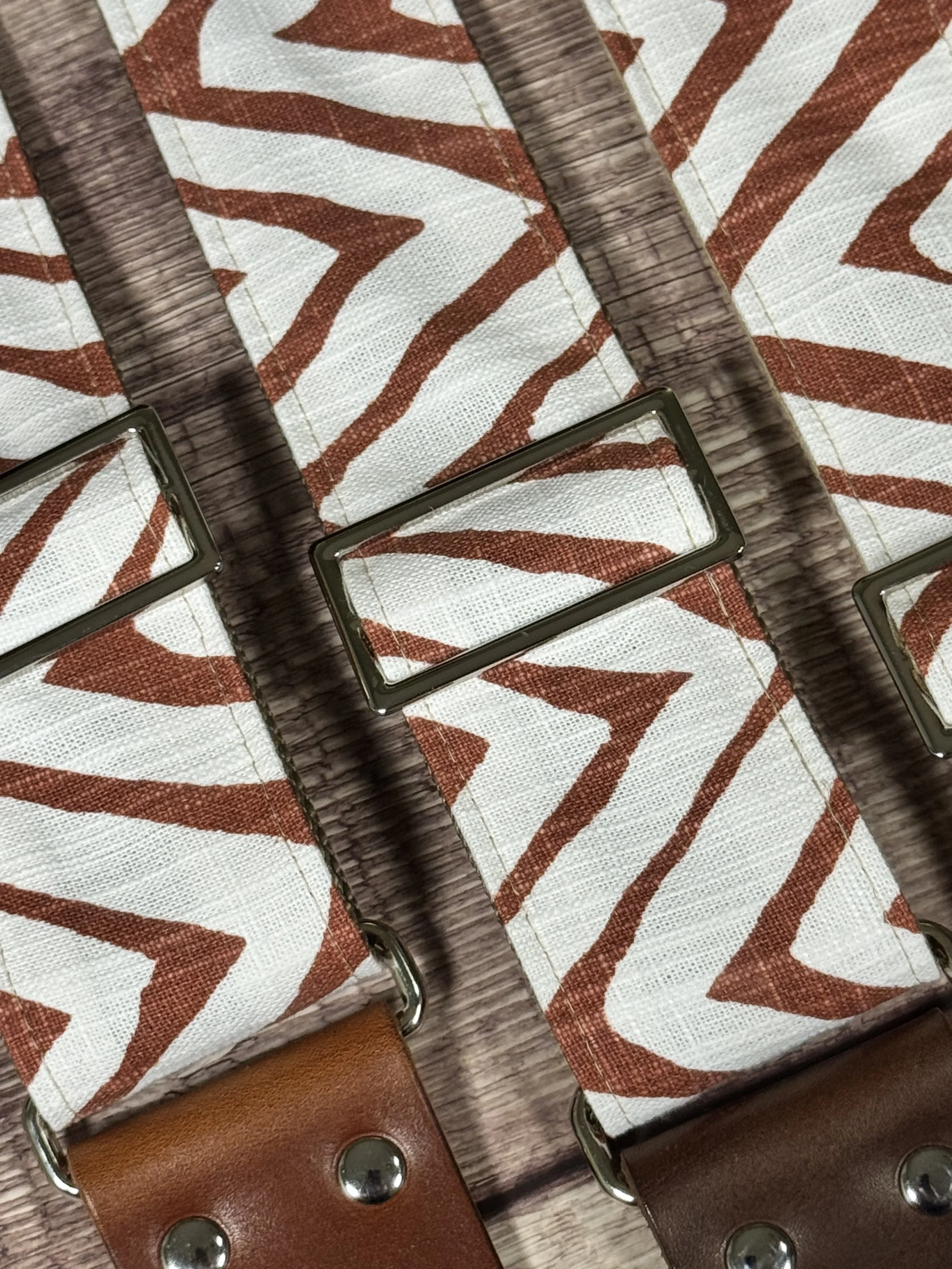 Petroglyph guitar strap featuring an earthy rust and cream geometric pattern by Josey Straps.
