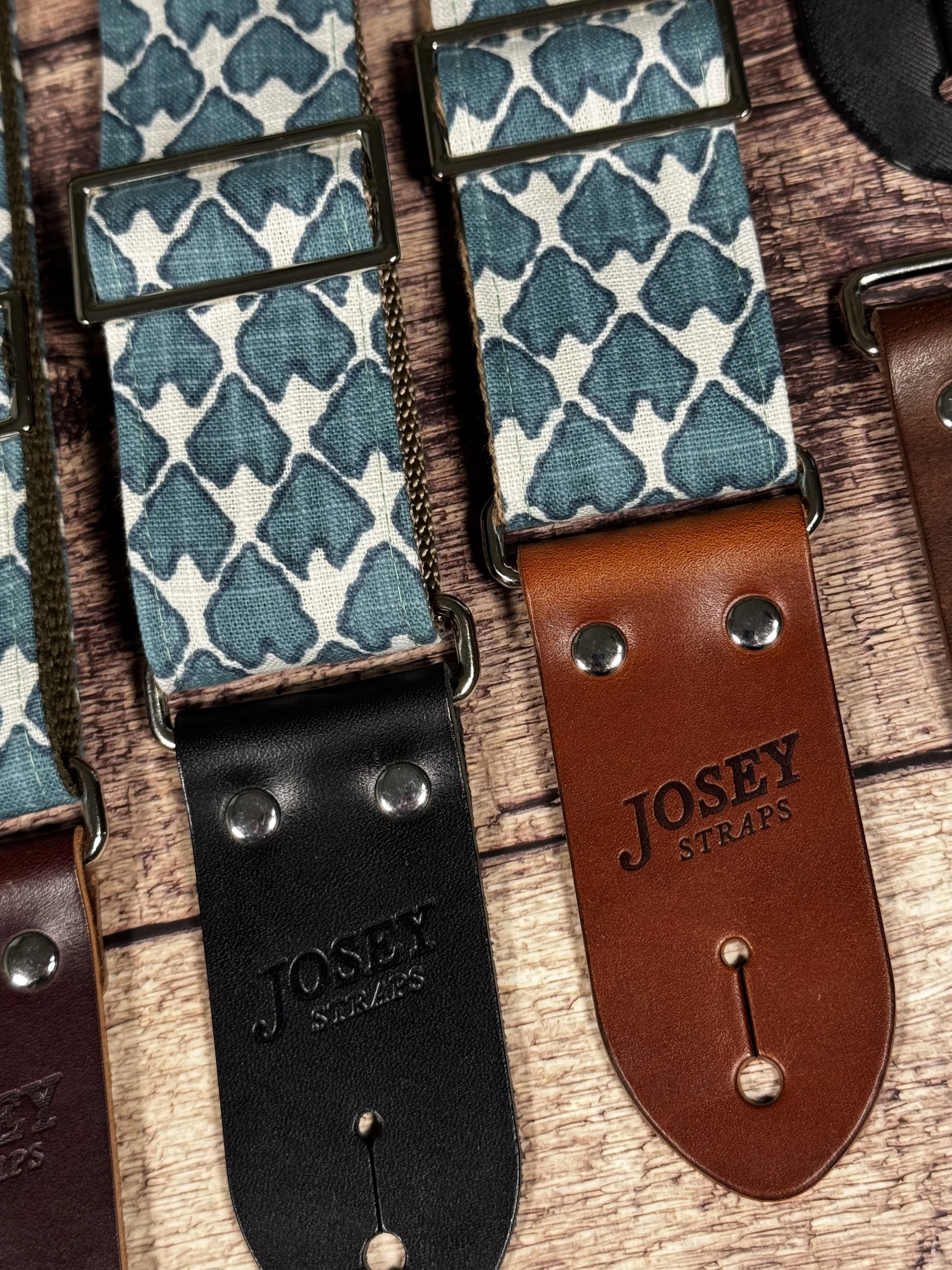 Wildwood guitar strap by Josey Straps featuring a teal geometric pattern set on an off-white background.  Finished with premium leather ends.