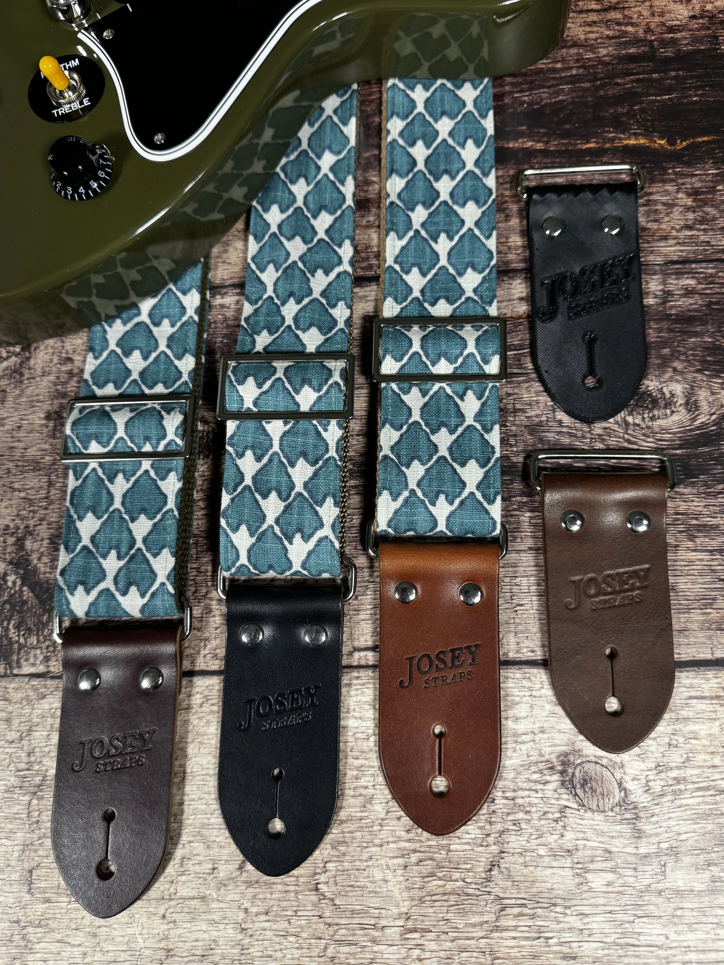 Wildwood guitar strap by Josey Straps featuring a teal geometric pattern set on an off-white background.  Finished with premium leather ends.