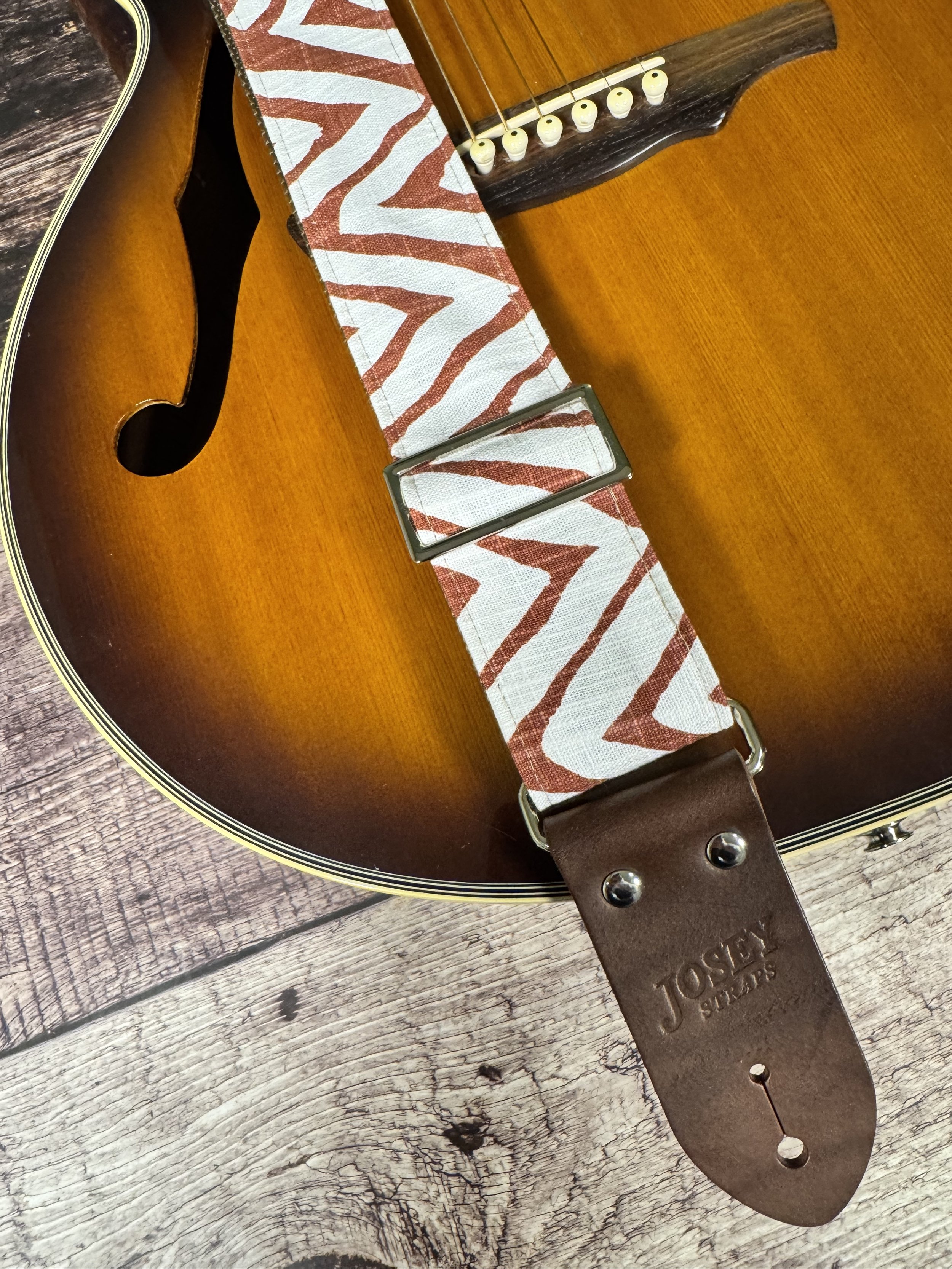 Petroglyph guitar strap featuring an earthy rust and cream geometric pattern by Josey Straps.