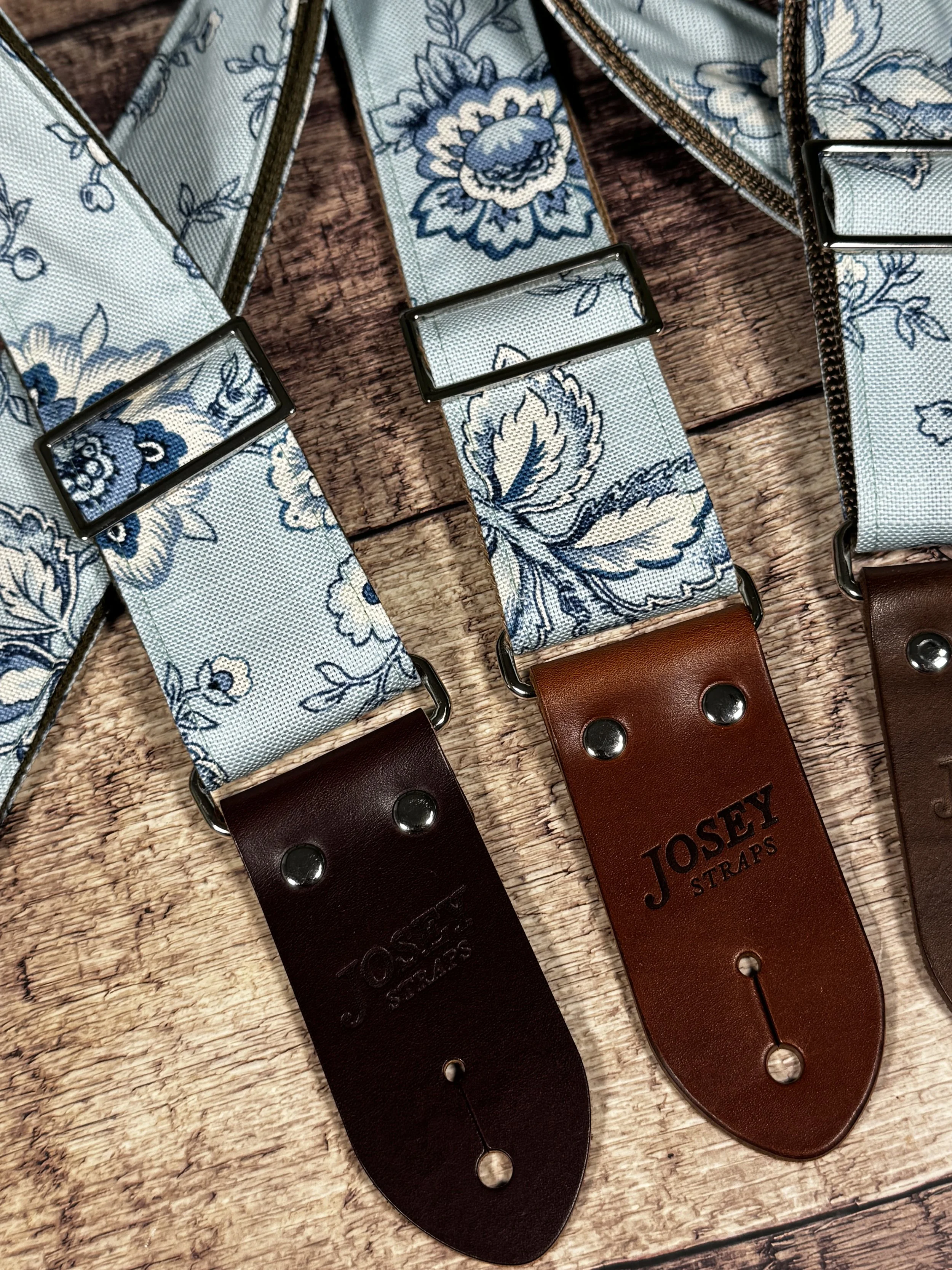 Something Blue floral guitar strap by Josey Straps featuring a powder blue and cream vintage floral pattern with premium leather ends.