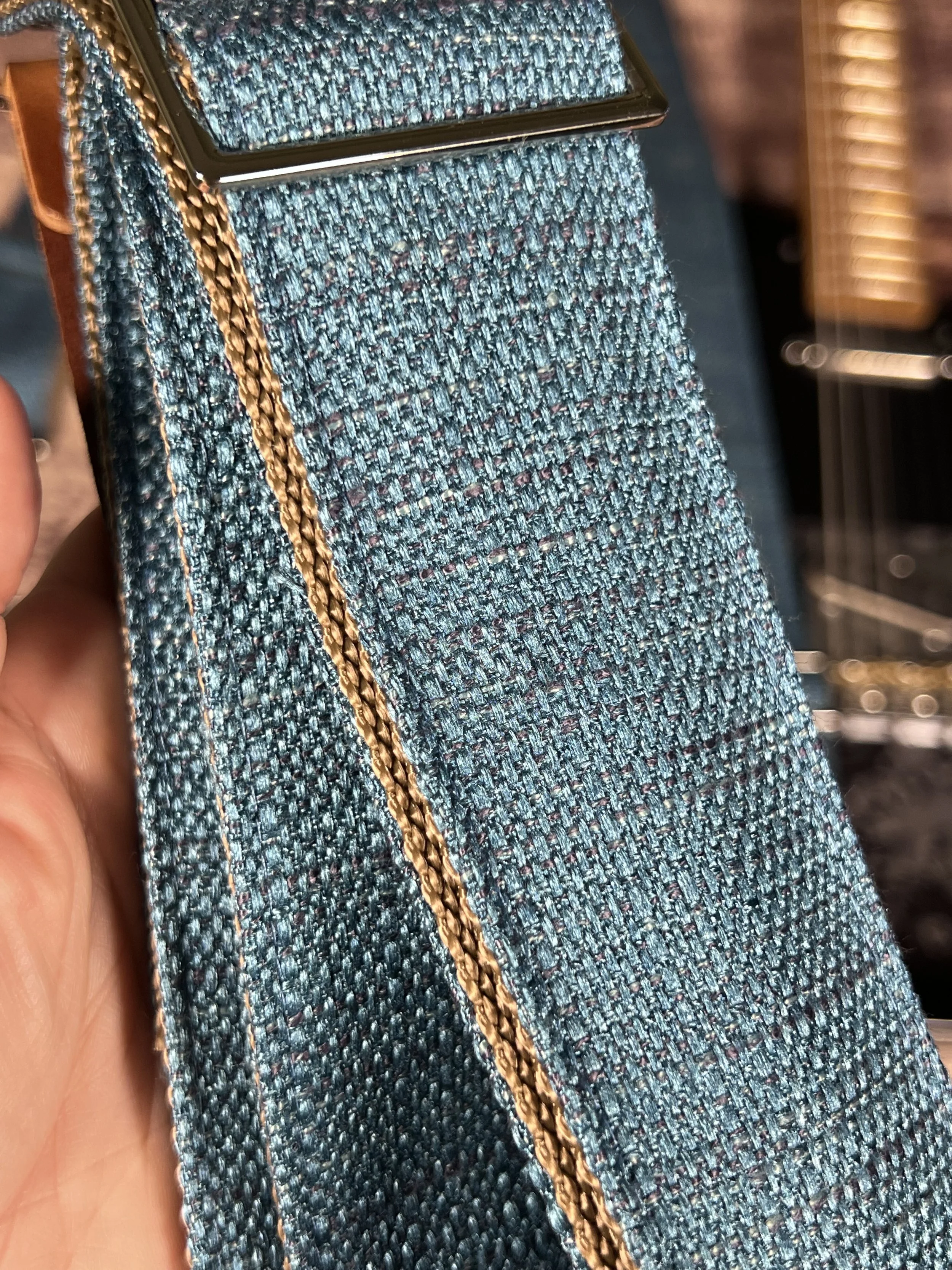 Up close picture of the Peacock Blue woven guitar strap with blue-green texture and leather ends by Josey Straps
