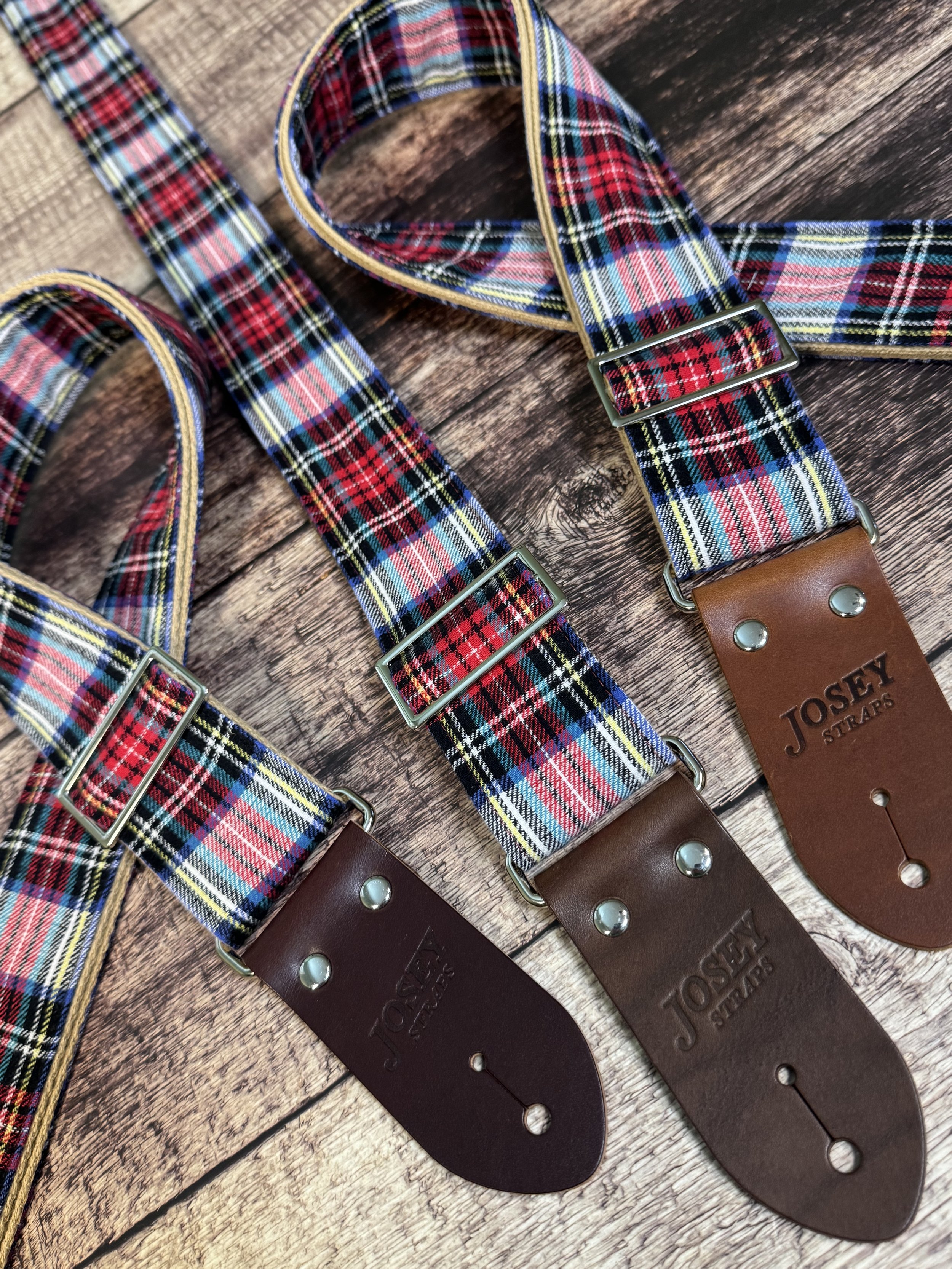 3 red and blue plaid guitar straps with premium leather ends by Josey Straps, 2 are folded