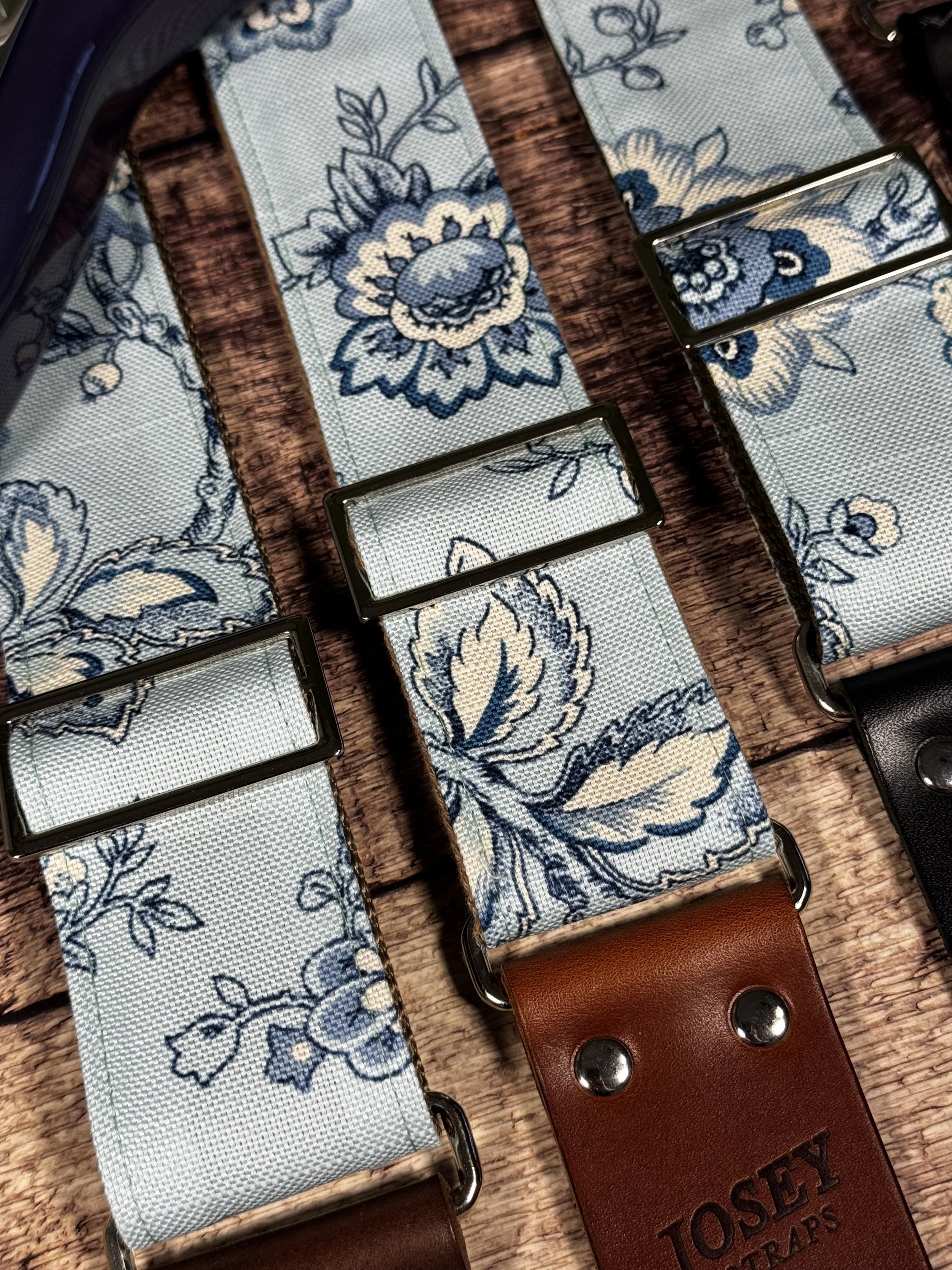 Something Blue floral guitar strap by Josey Straps featuring a powder blue and cream vintage floral pattern with premium leather ends.