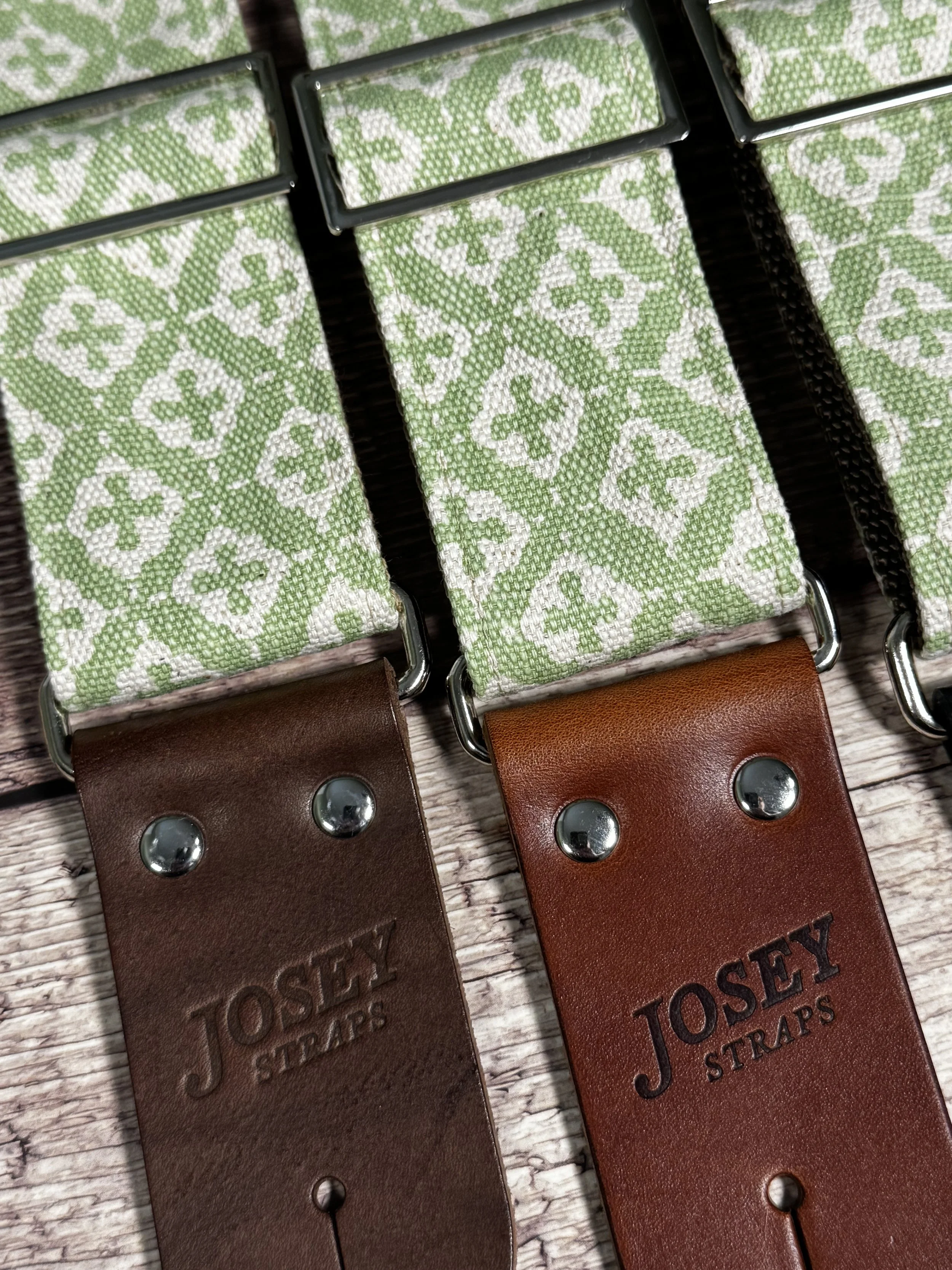 The Green House handmade guitar strap by Josey Straps featuring a sage green and cream geometric pattern with premium leather ends.