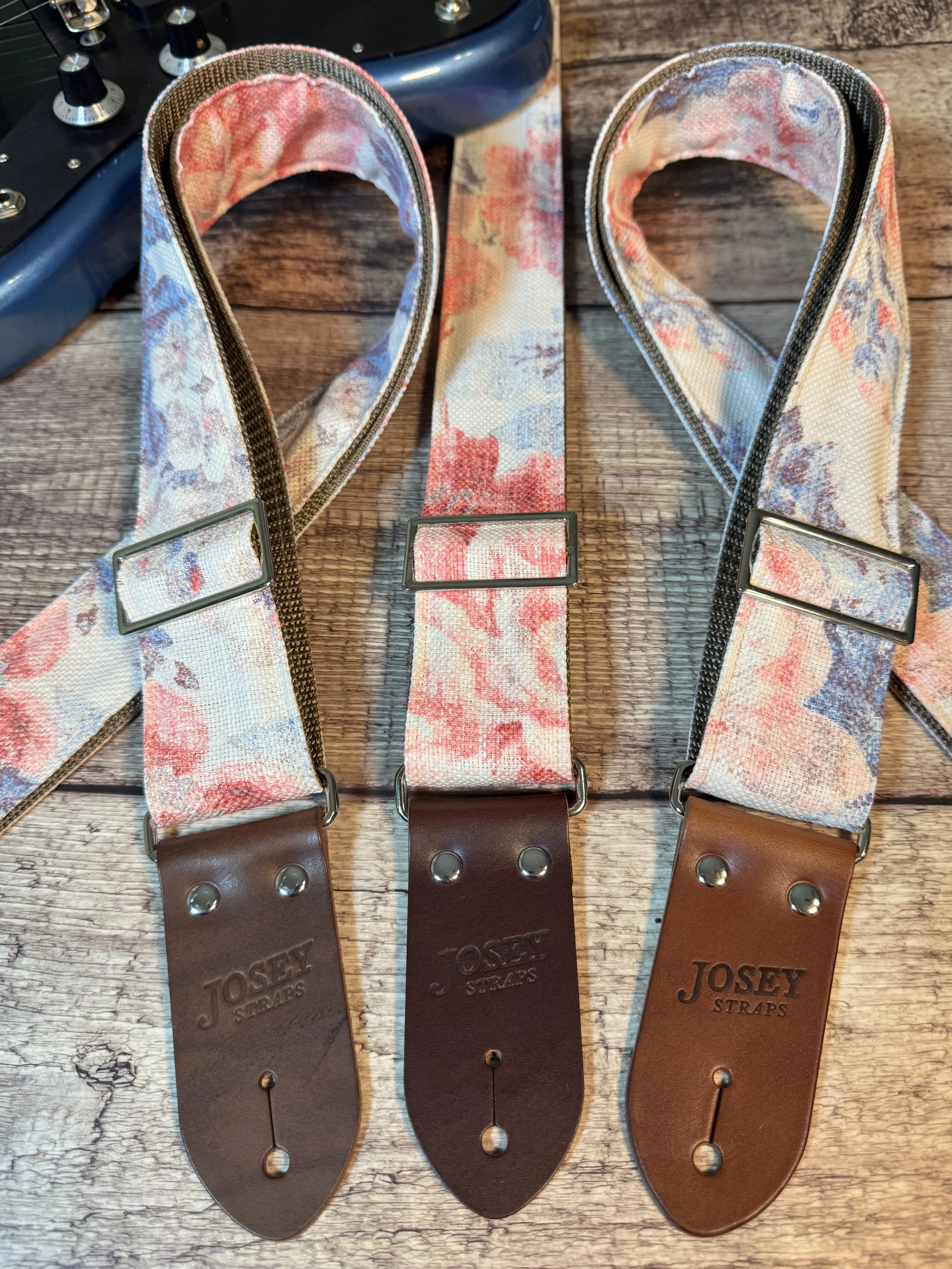 Kensington handmade floral guitar strap by Josey Straps with watercolor pink and blue floral fabric and premium leather ends.