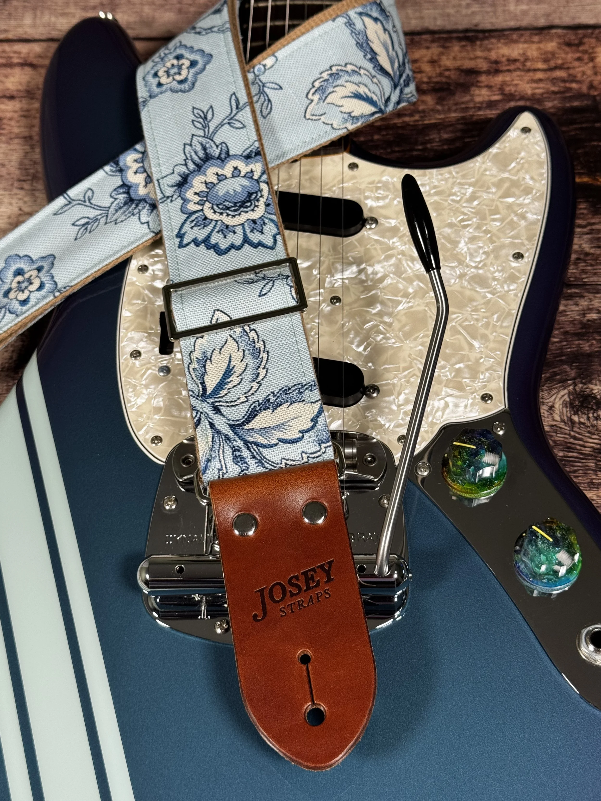 Something Blue floral guitar strap by Josey Straps featuring a powder blue and cream vintage floral pattern with premium leather ends.