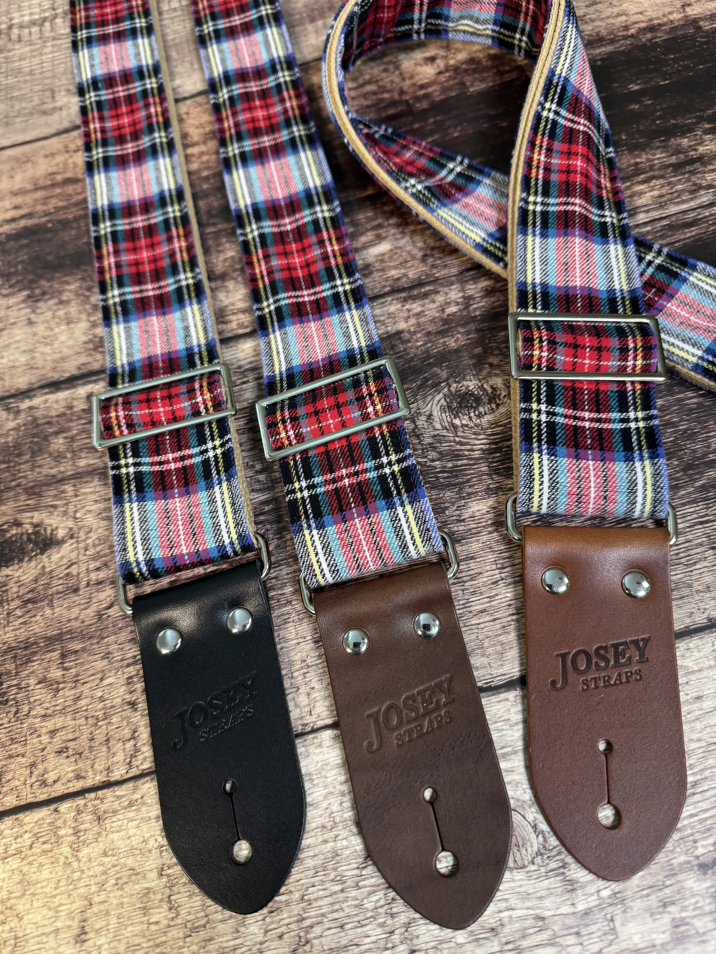 3 Dad Plaid red and blue plaid guitar straps, one is folded