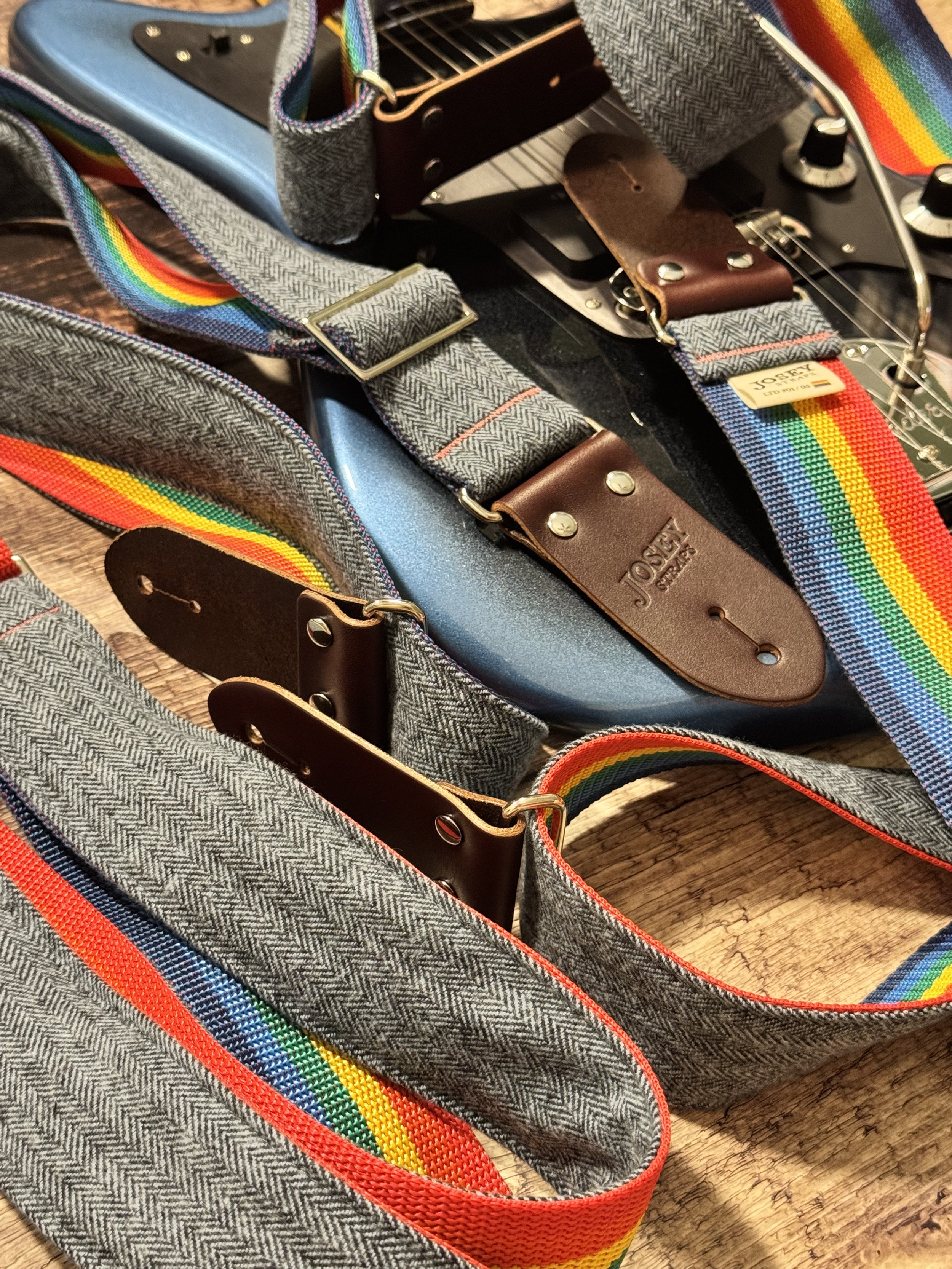Ally limited-edition guitar strap featuring blue-on-blue herringbone flannel, rainbow backing, and Sunset leather ends by Josey Straps