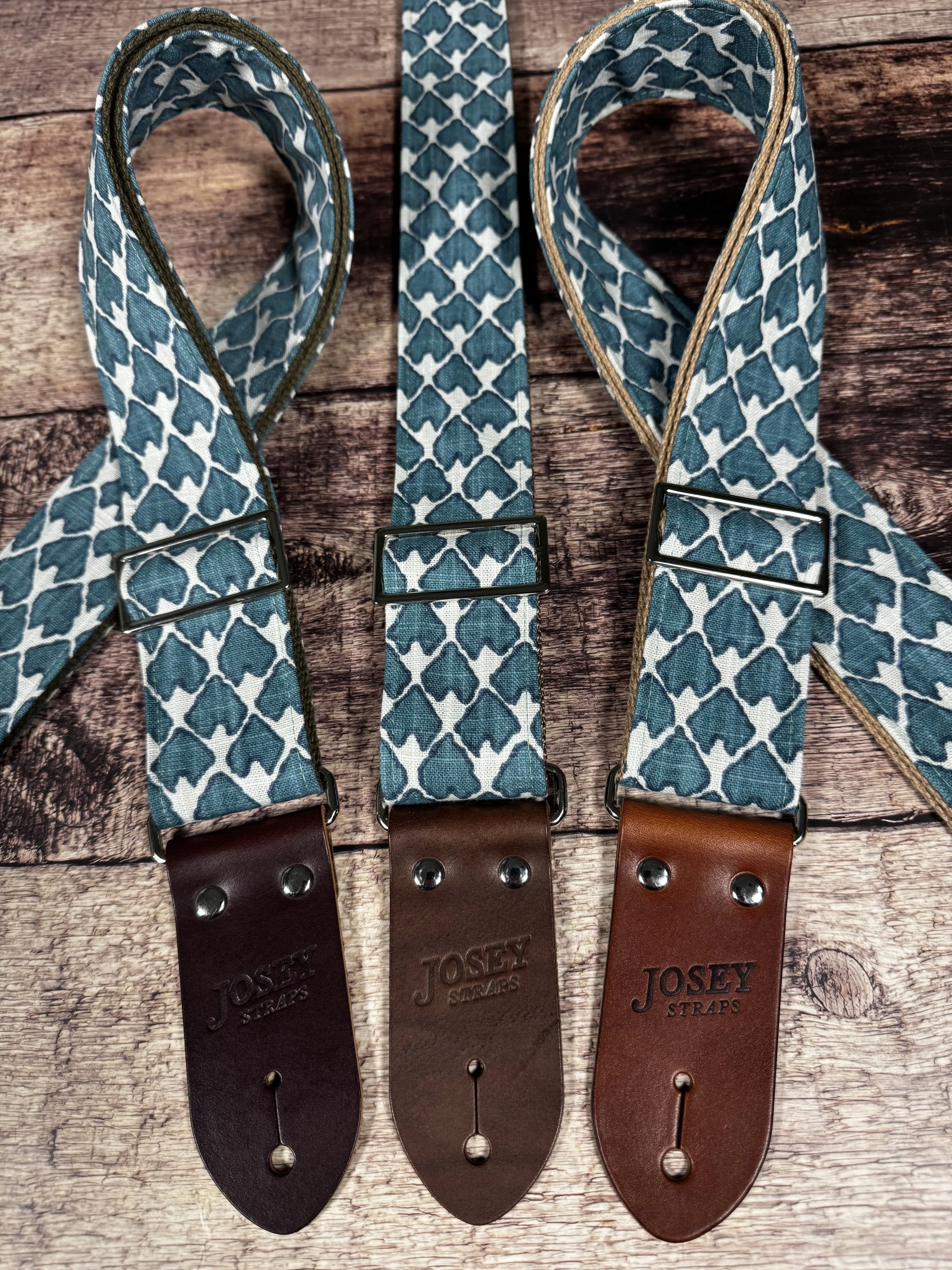 Wildwood guitar strap by Josey Straps featuring a teal geometric pattern set on an off-white background.  Finished with premium leather ends.