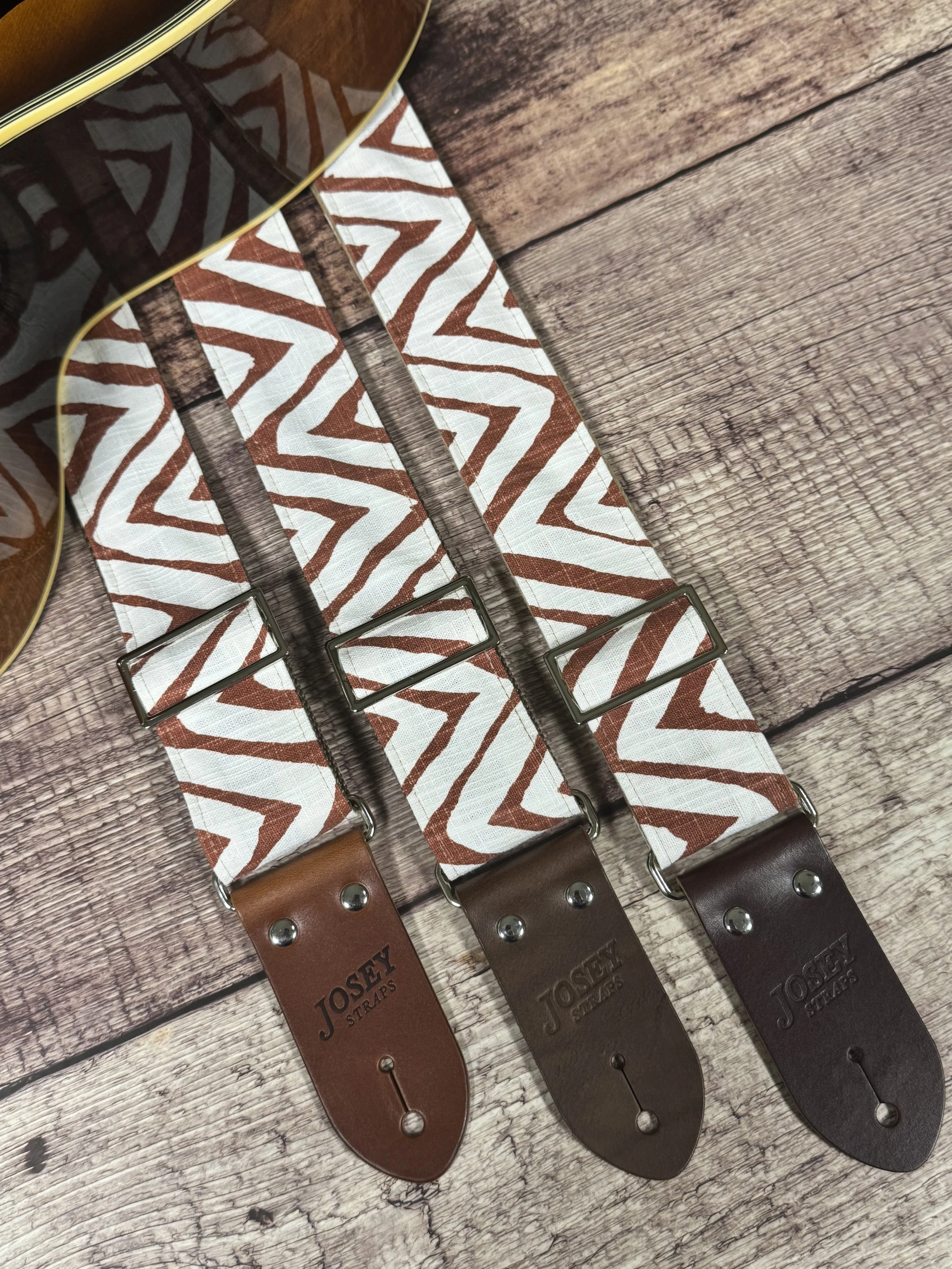 Petroglyph guitar strap featuring an earthy rust and cream geometric pattern by Josey Straps.