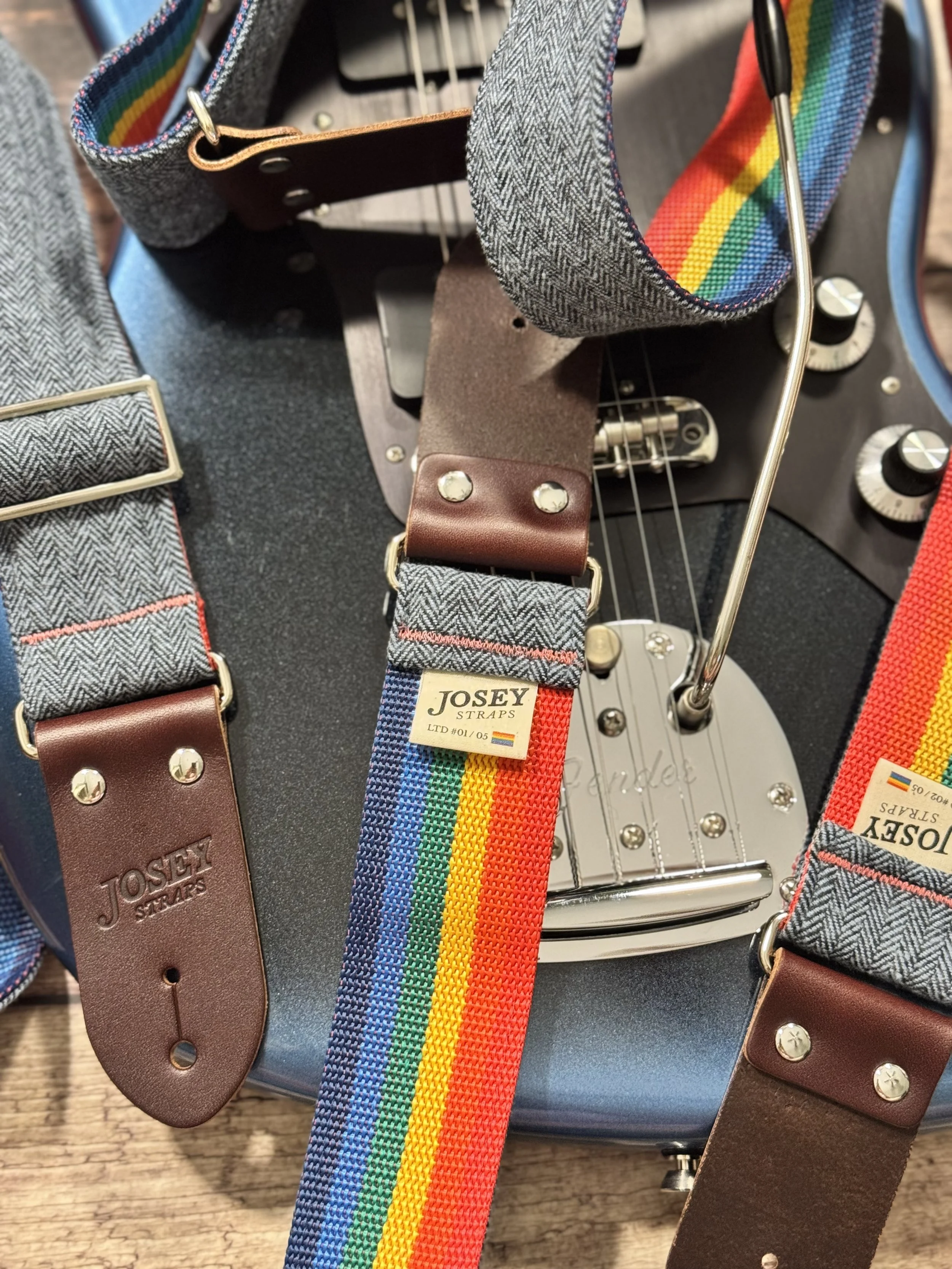 Ally limited-edition guitar strap featuring blue-on-blue herringbone flannel, rainbow backing, and Sunset leather ends by Josey Straps
