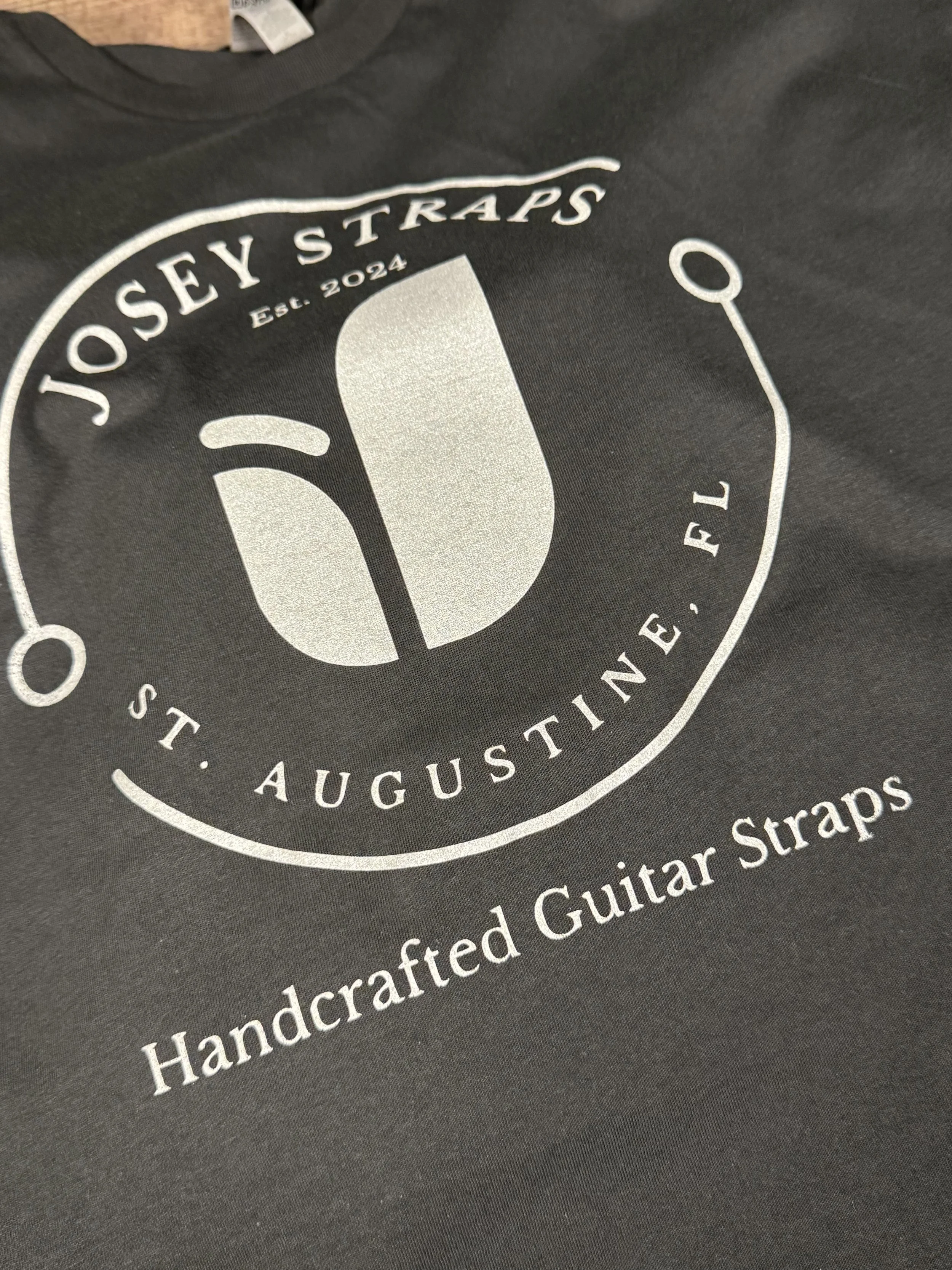Up close shot of a vintage black Josey Straps screen printed t-shirt