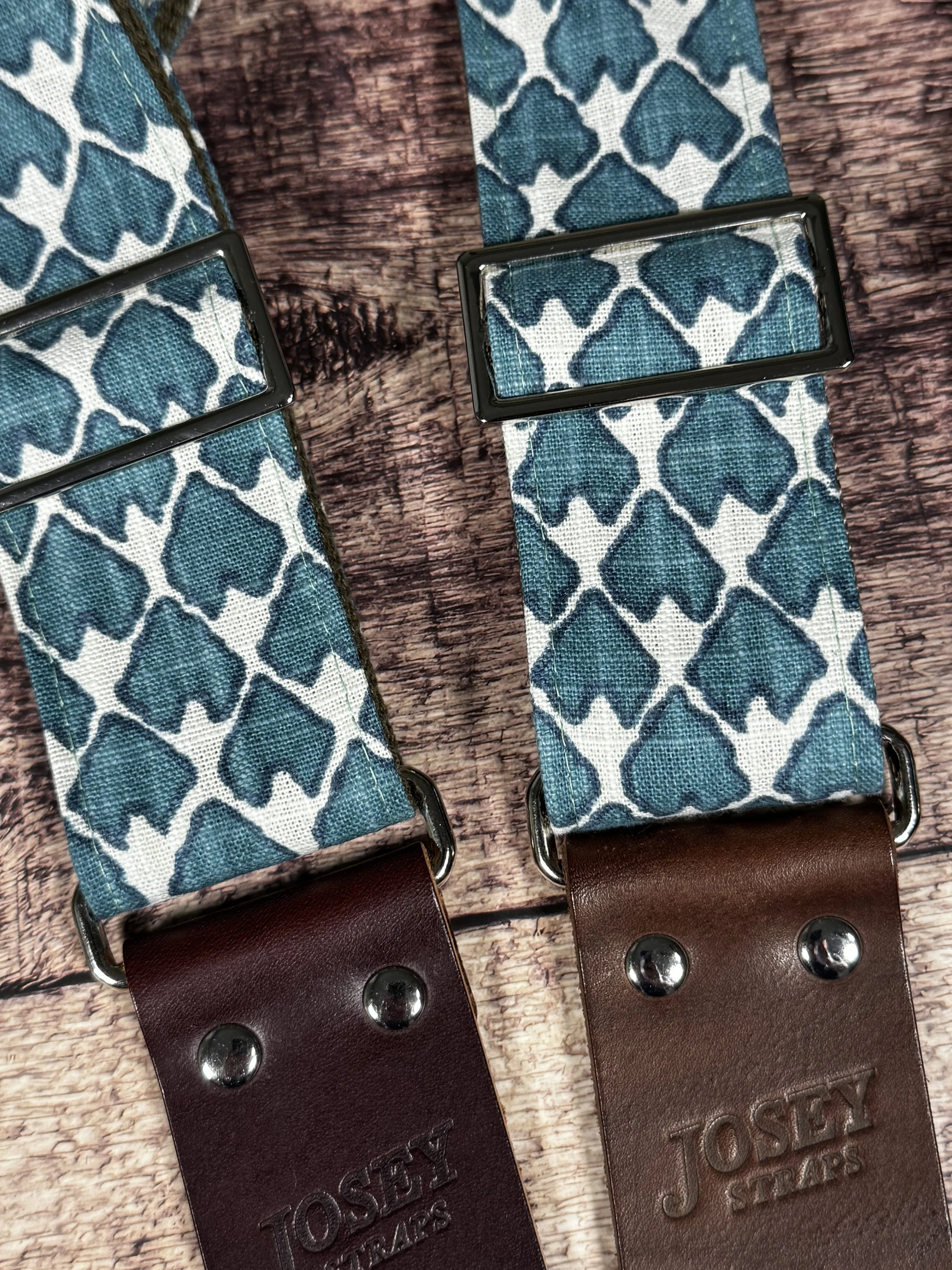 Wildwood guitar strap by Josey Straps featuring a teal geometric pattern set on an off-white background.  Finished with premium leather ends.