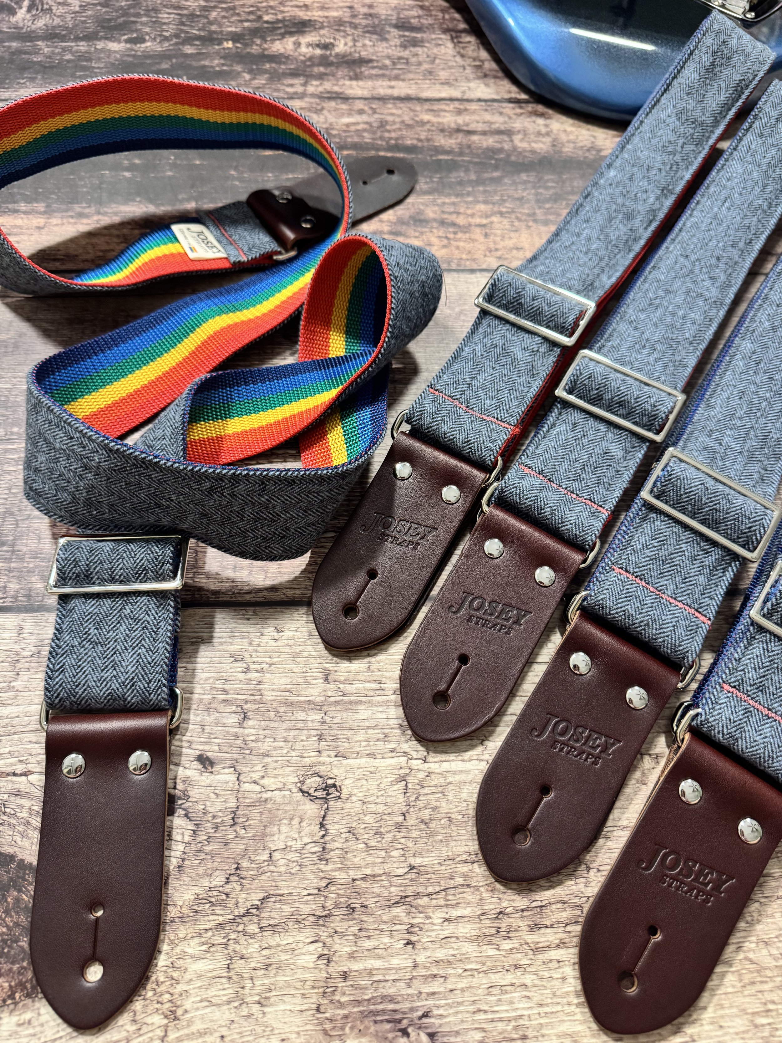 Ally limited-edition guitar strap featuring blue-on-blue herringbone flannel, rainbow backing, and Sunset leather ends by Josey Straps