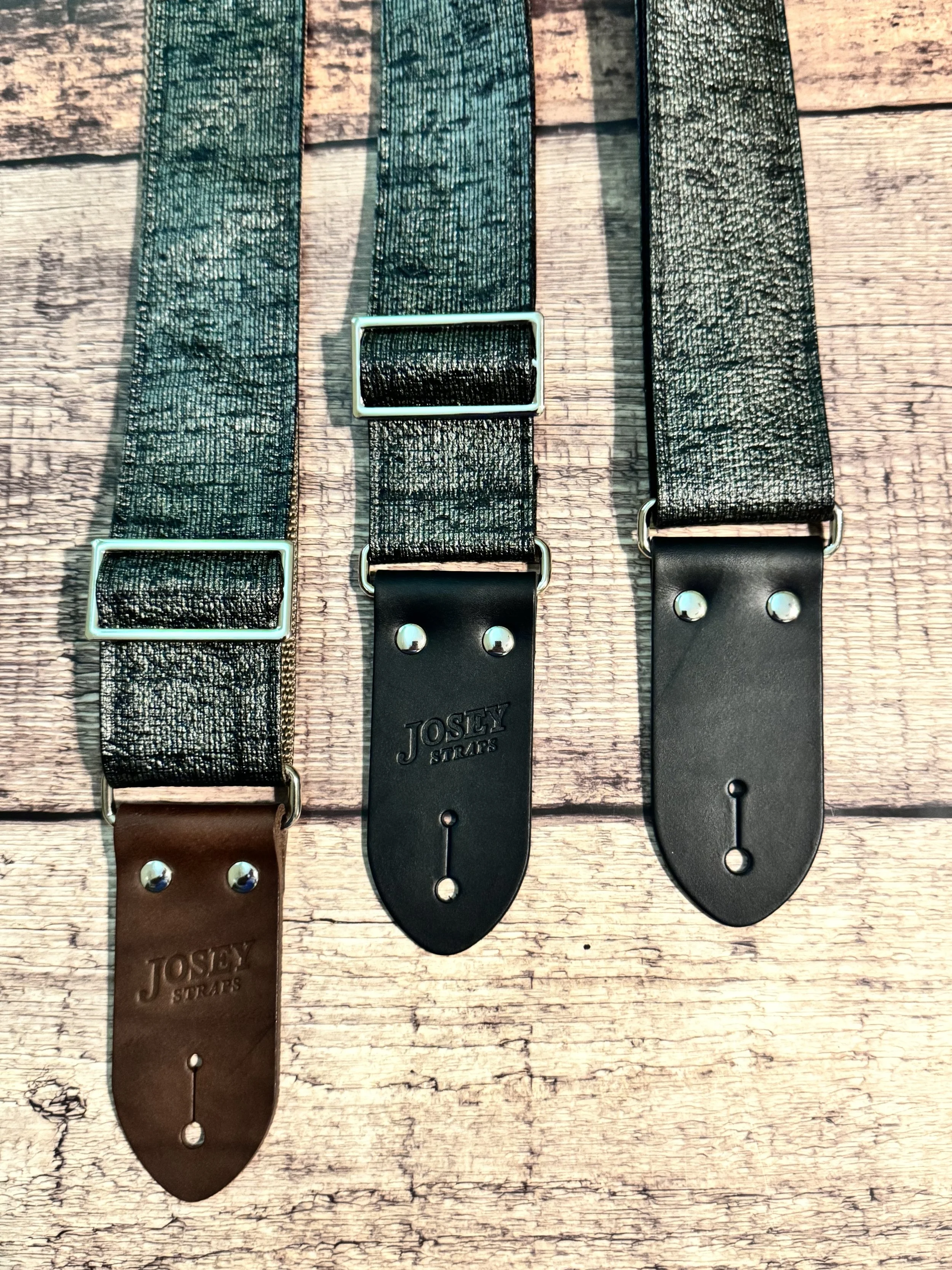 Pewter Slub guitar straps on wooden floor.