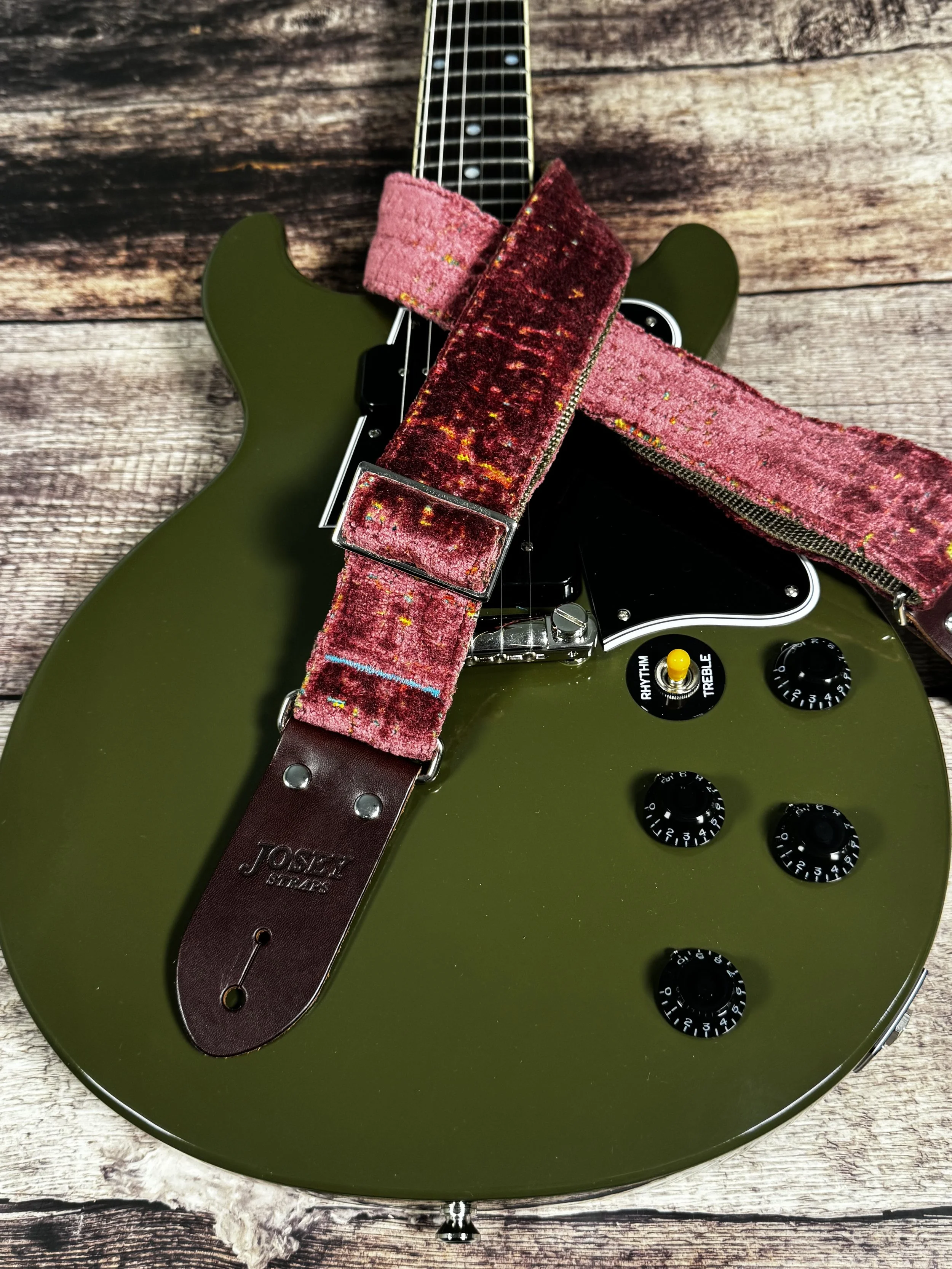 Telly handmade pink guitar strap by Josey Straps featuring textured dusty-rose fabric with colorful flecks and premium leather ends.