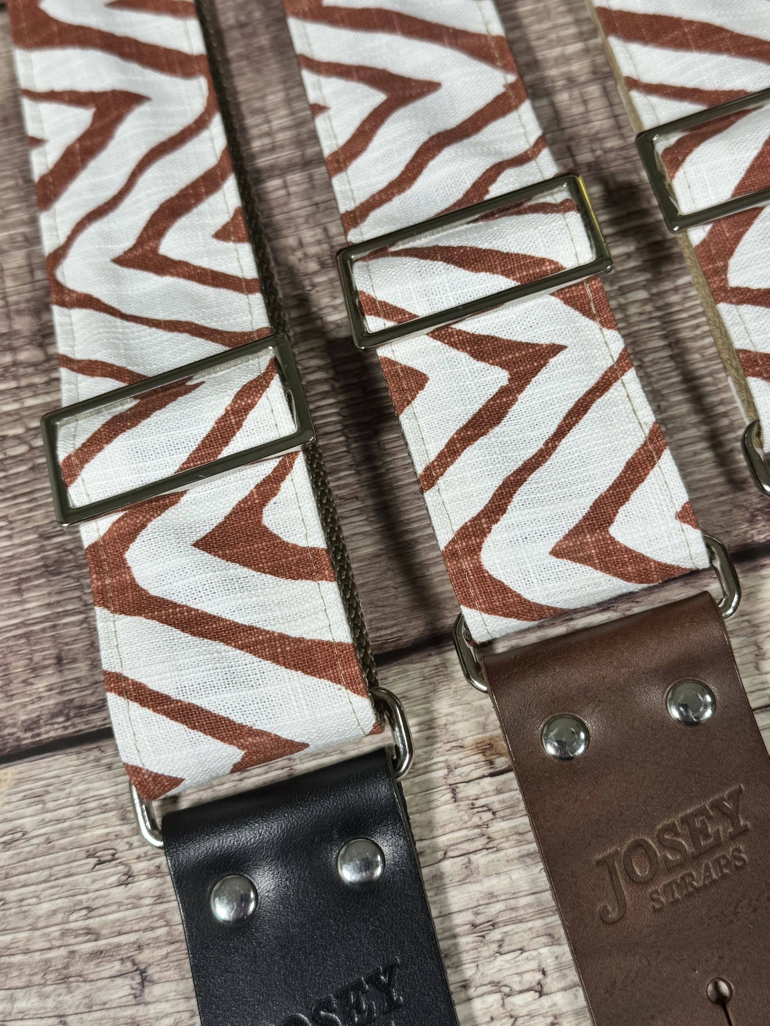 Petroglyph guitar strap featuring an earthy rust and cream geometric pattern by Josey Straps.