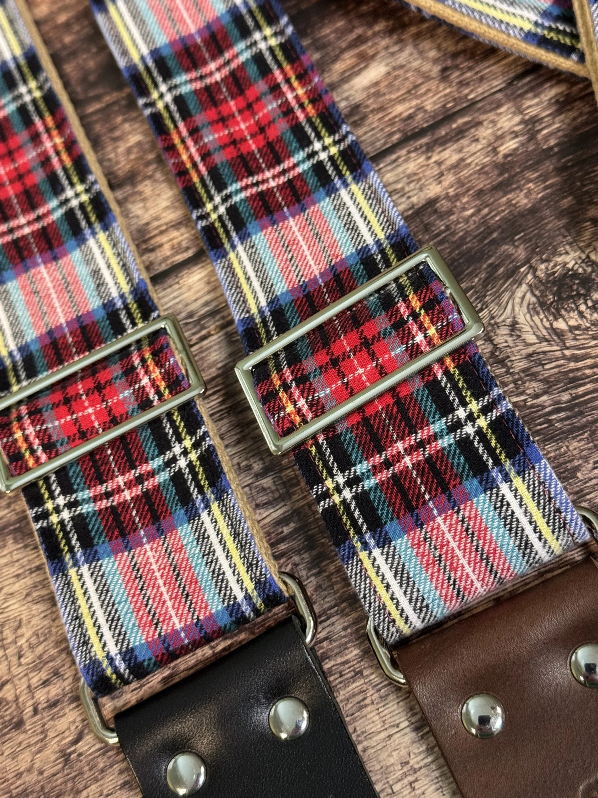 up close red and blue plaid guitar strap with silver slides