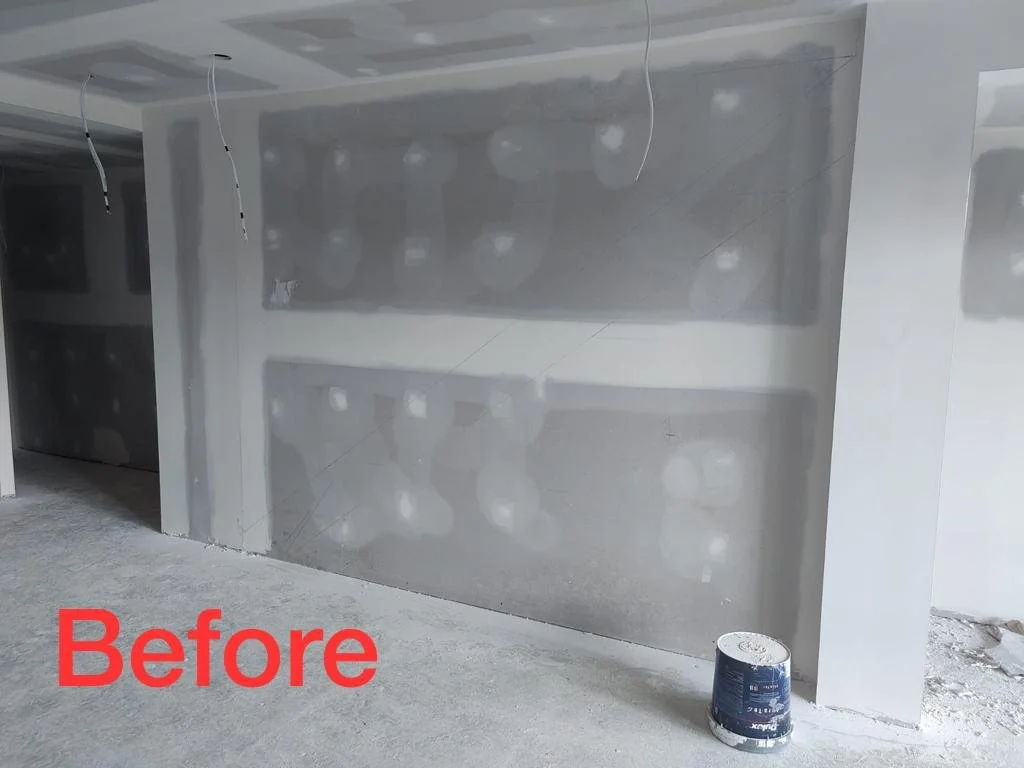 Before under stairs space with plain white wall and closed railing