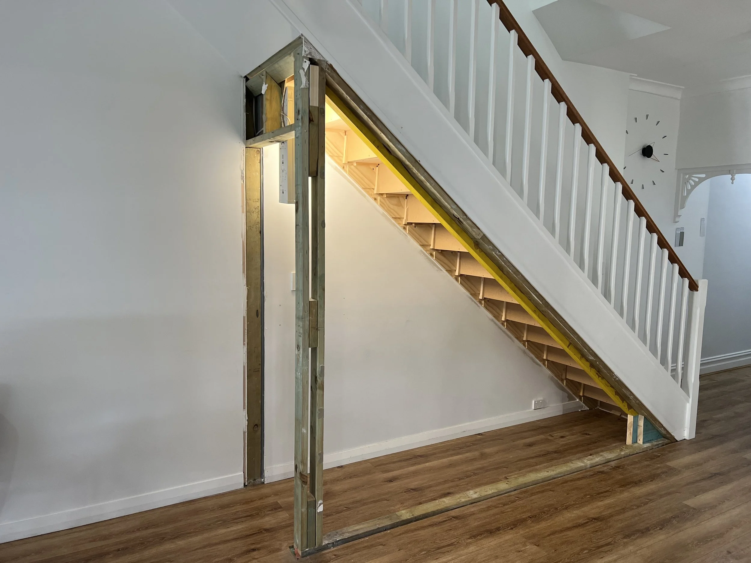 Before stairs showing open area without built-in storage