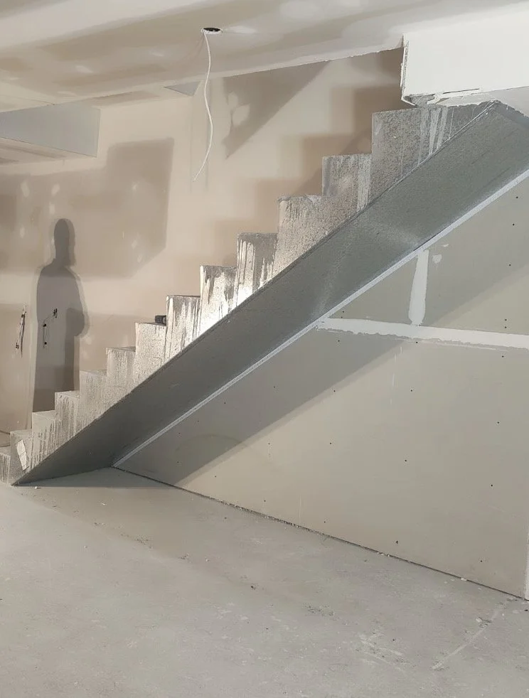 Before staircase with unused storage potential under stairs