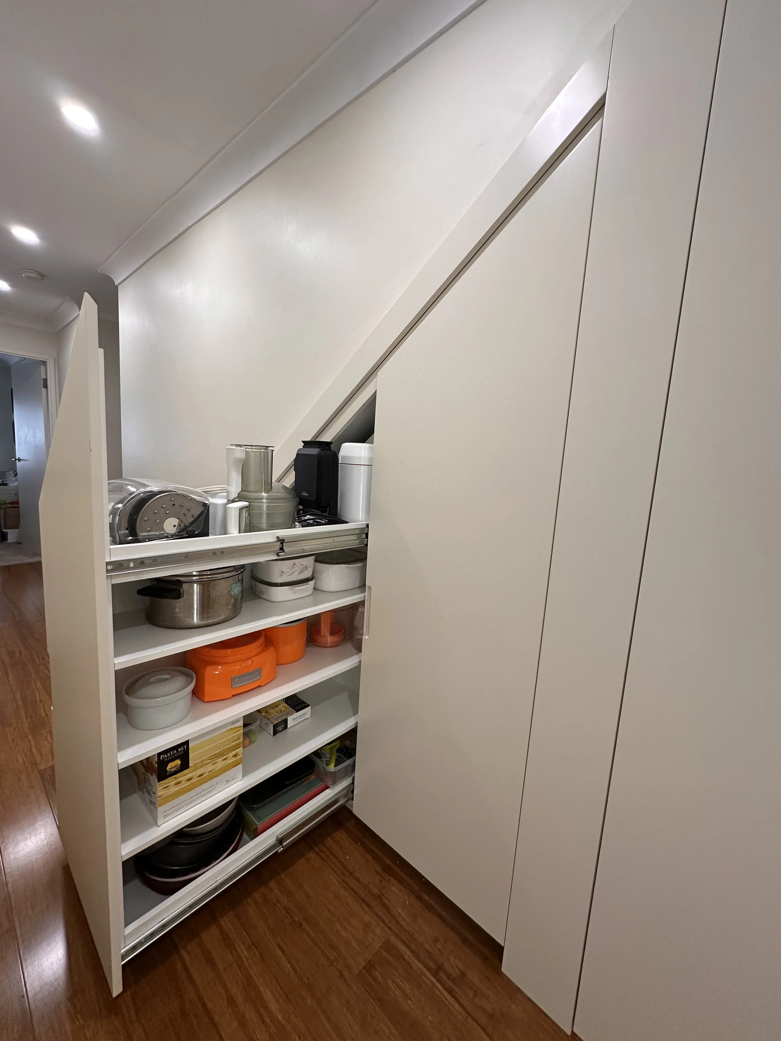 Modern under stairs storage solution with satin polyurethane cabinetry