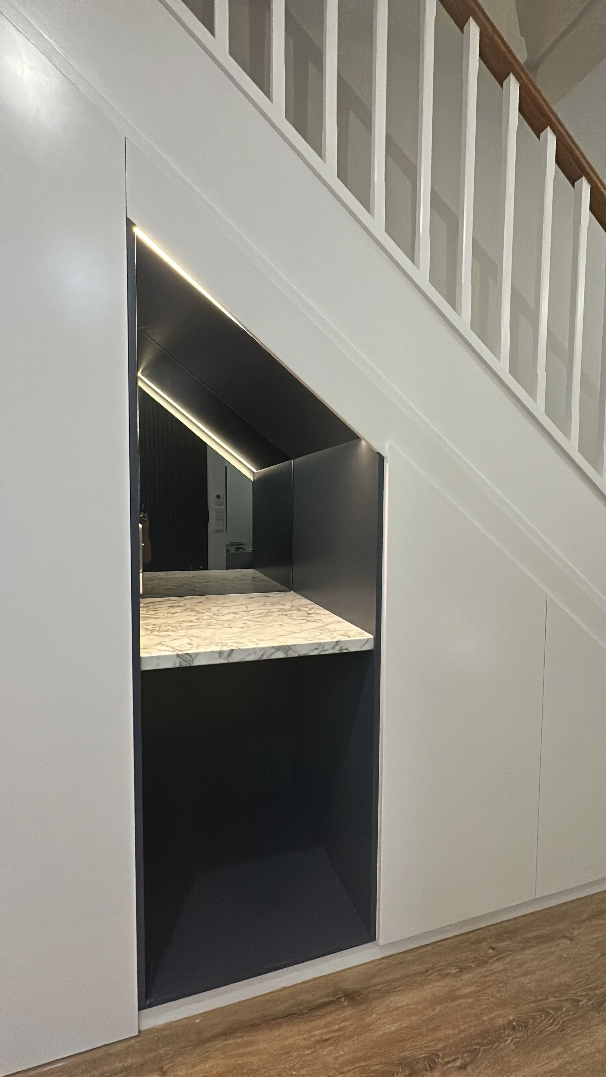 After cabinetry install showing full under stairs storage unit