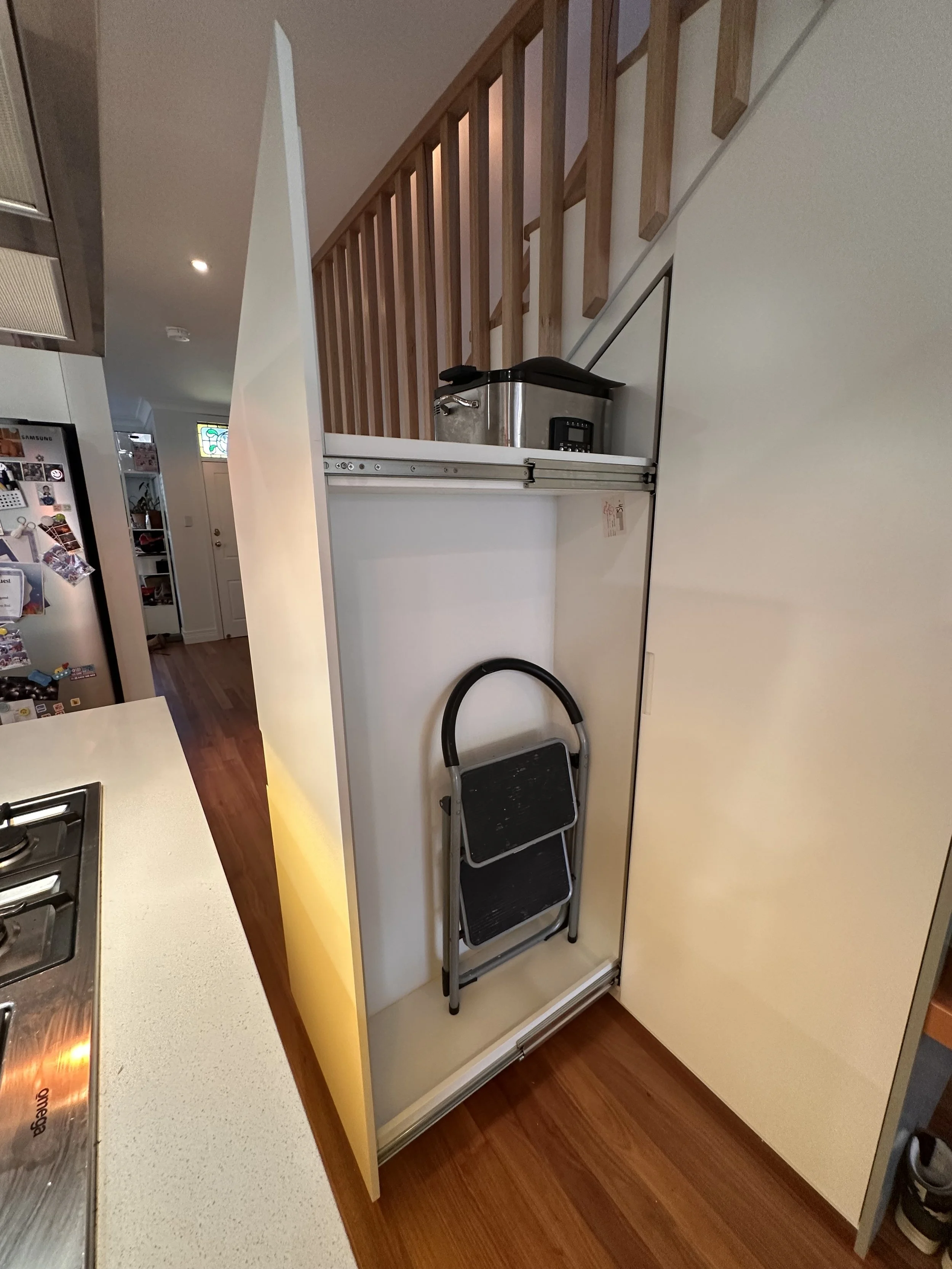 Modern under stairs cabinetry with integrated storage compartments