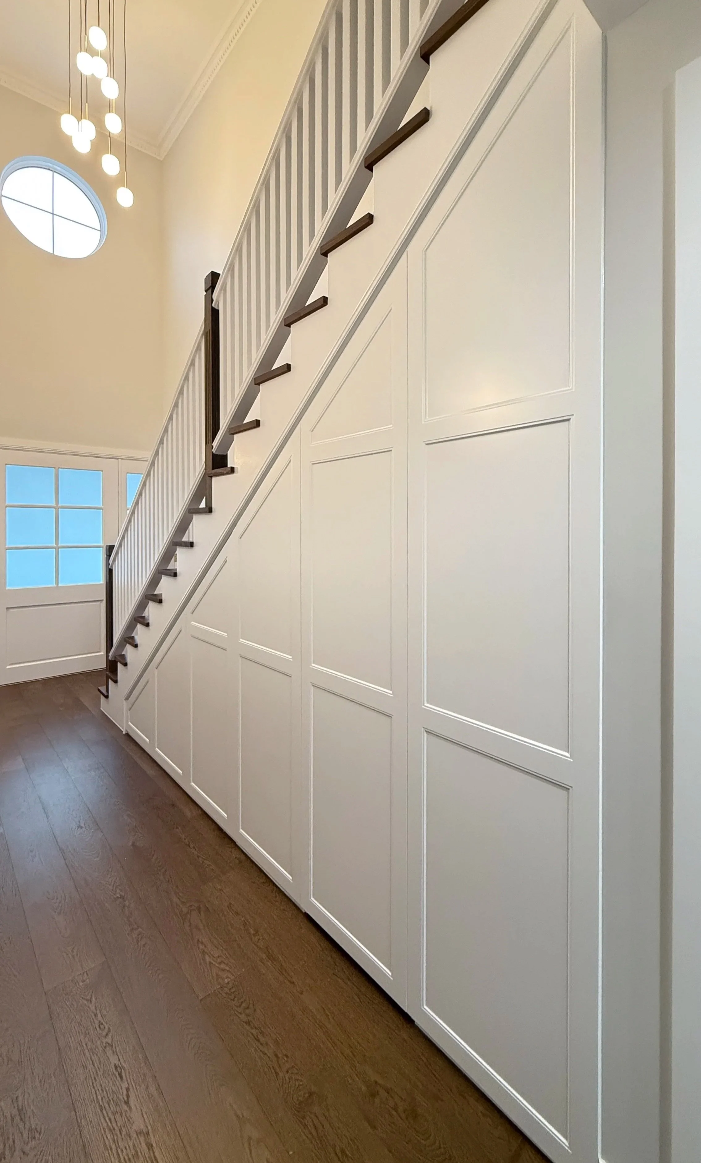 Completed custom under-stairs cabinetry in Sydney with seamless Shaker-style panels fitted beneath the staircase.