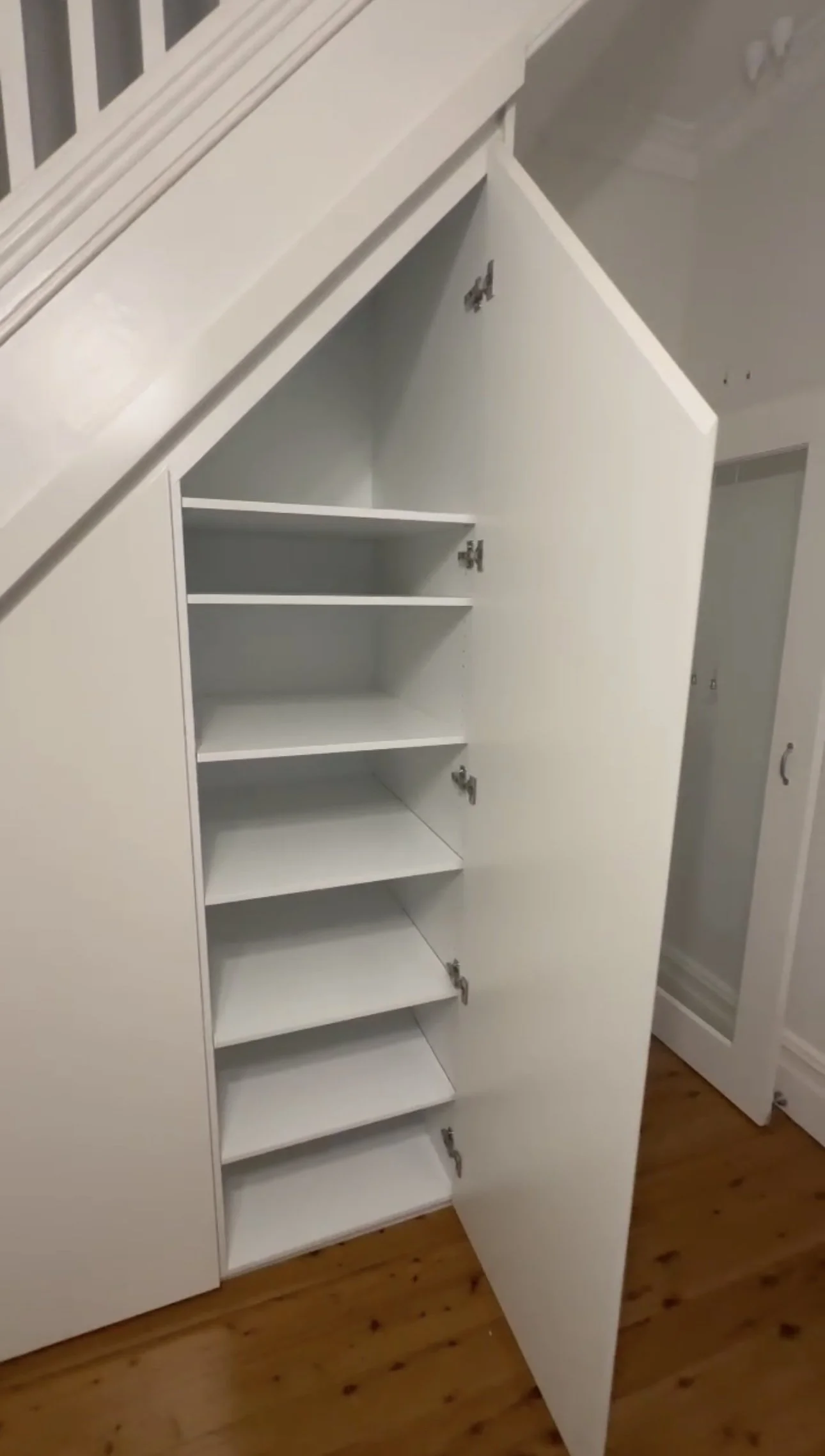 Modern under stairs storage with adjustable shelving and satin polyurethane finish