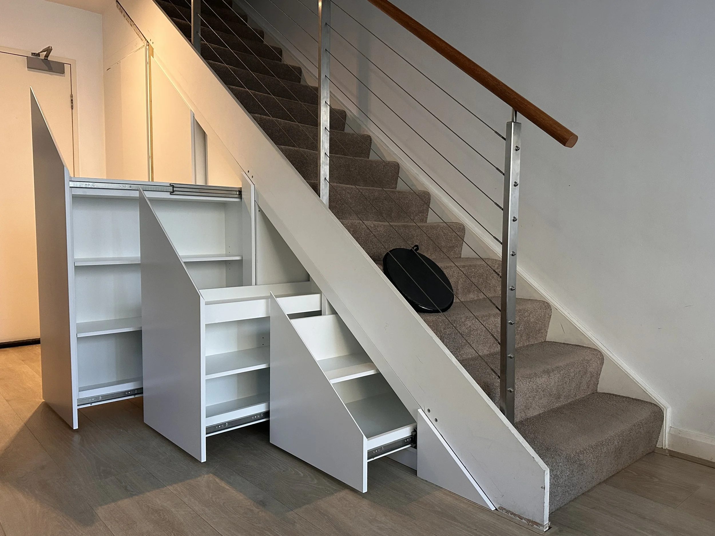 Full under stairs storage solution with drawers, shelving, and panel doors
