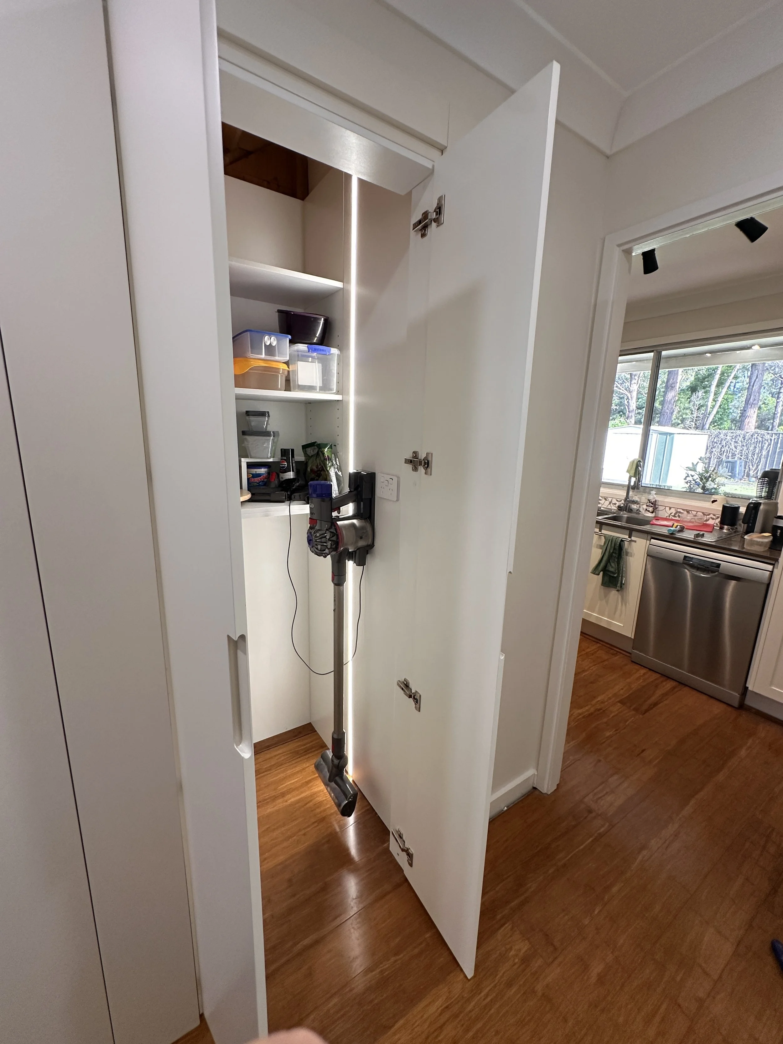 After installation of cabinetry with satin white polyurethane doors