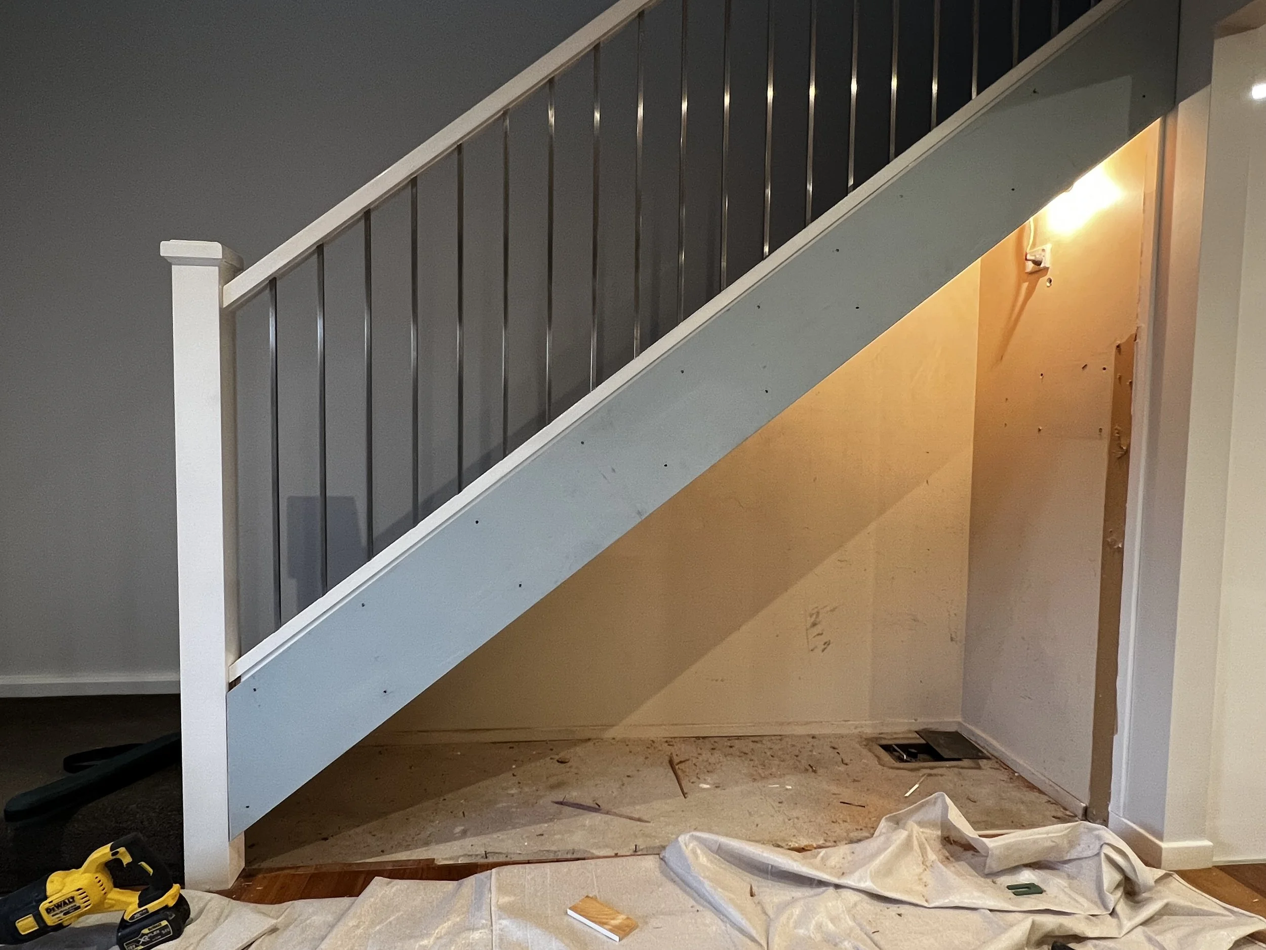 Before staircase with unused storage potential under stairs