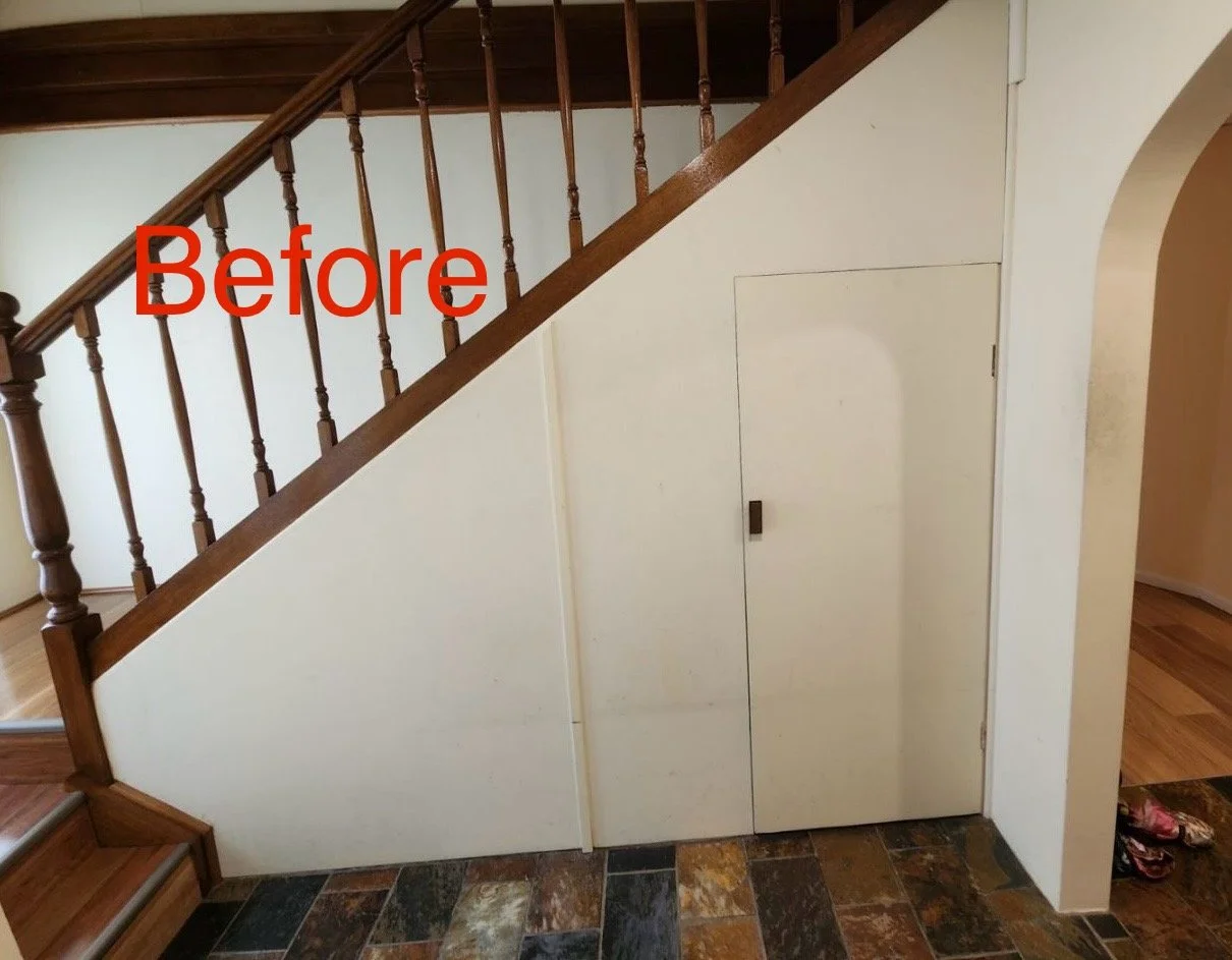 Before home staircase showing unused under stairs area