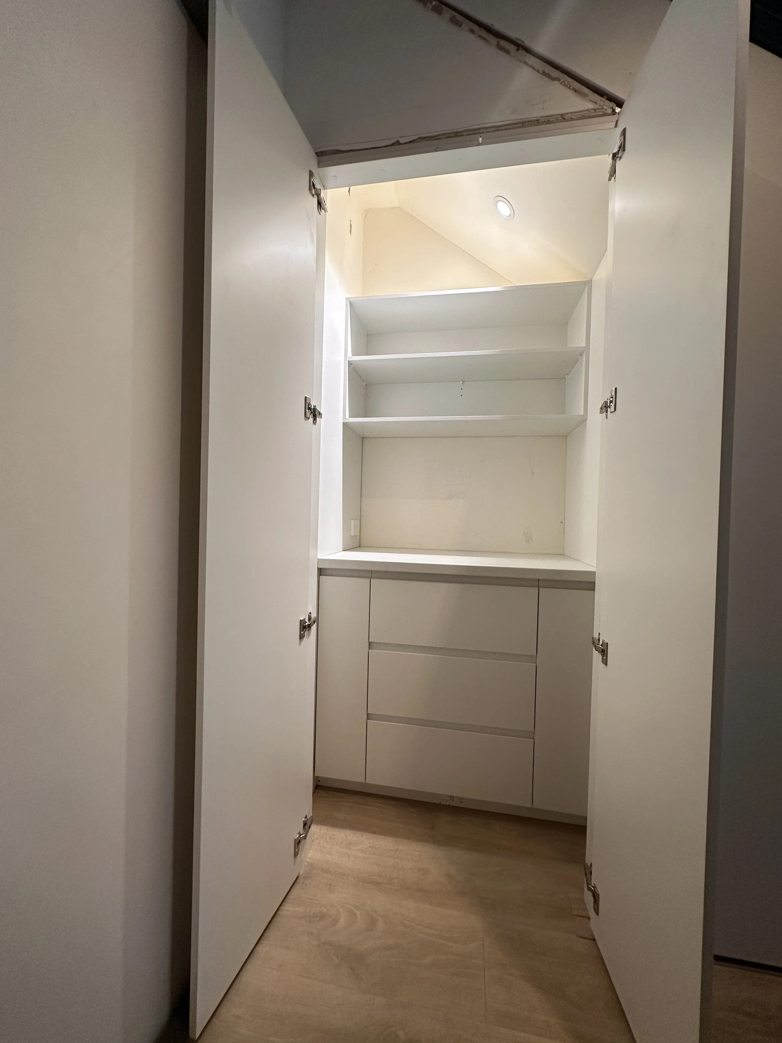 Modern under stairs cabinetry with integrated storage compartments