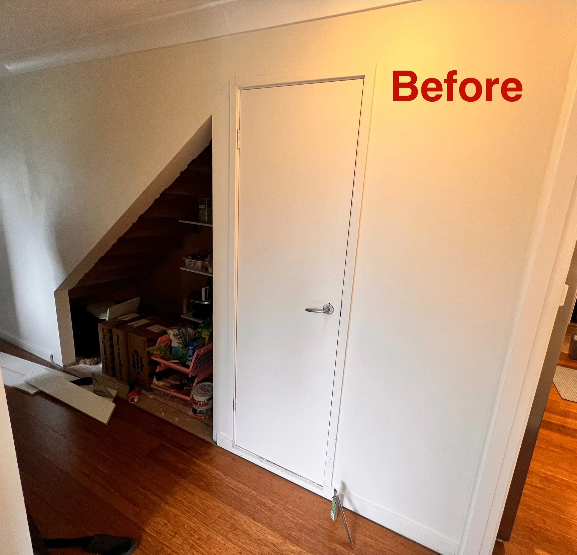 Under stairs space with no cabinetry, ready for custom storage installation