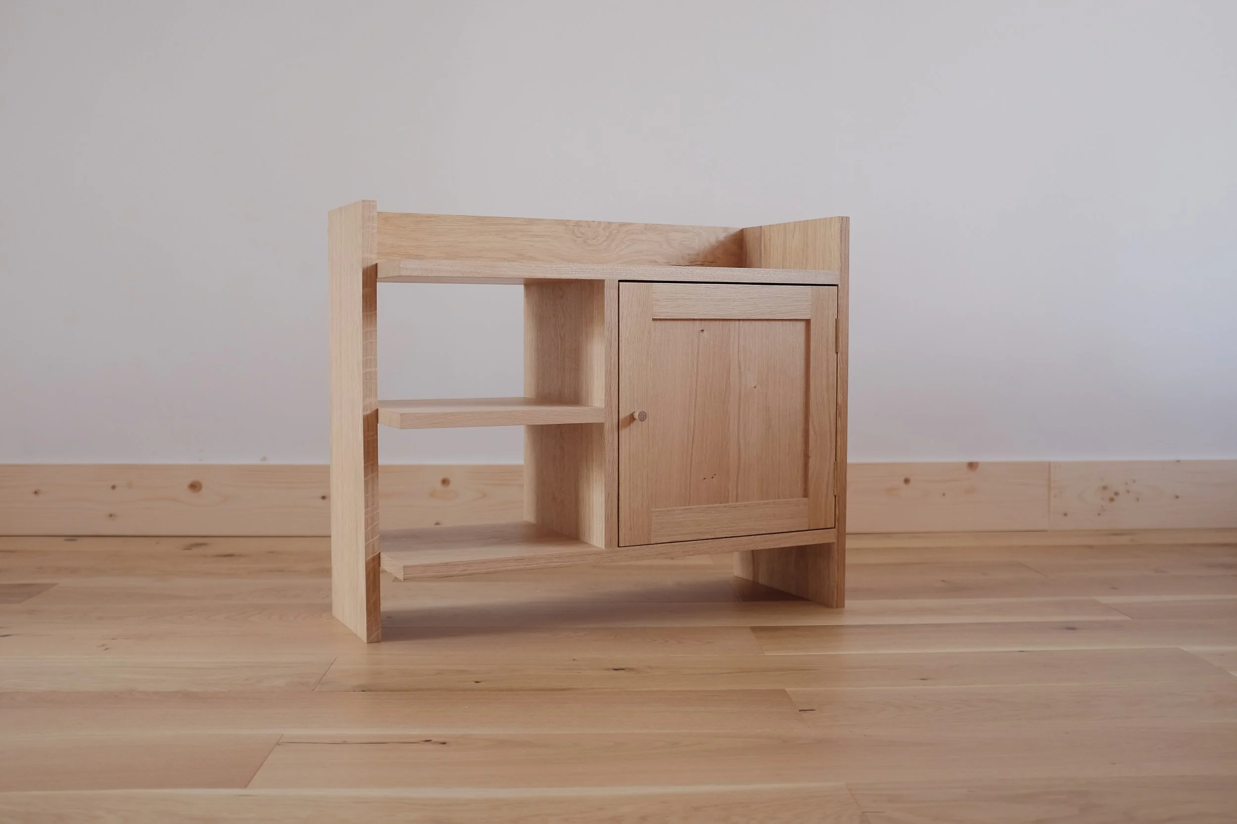 Solid oak bedside cabinet with open shelves.