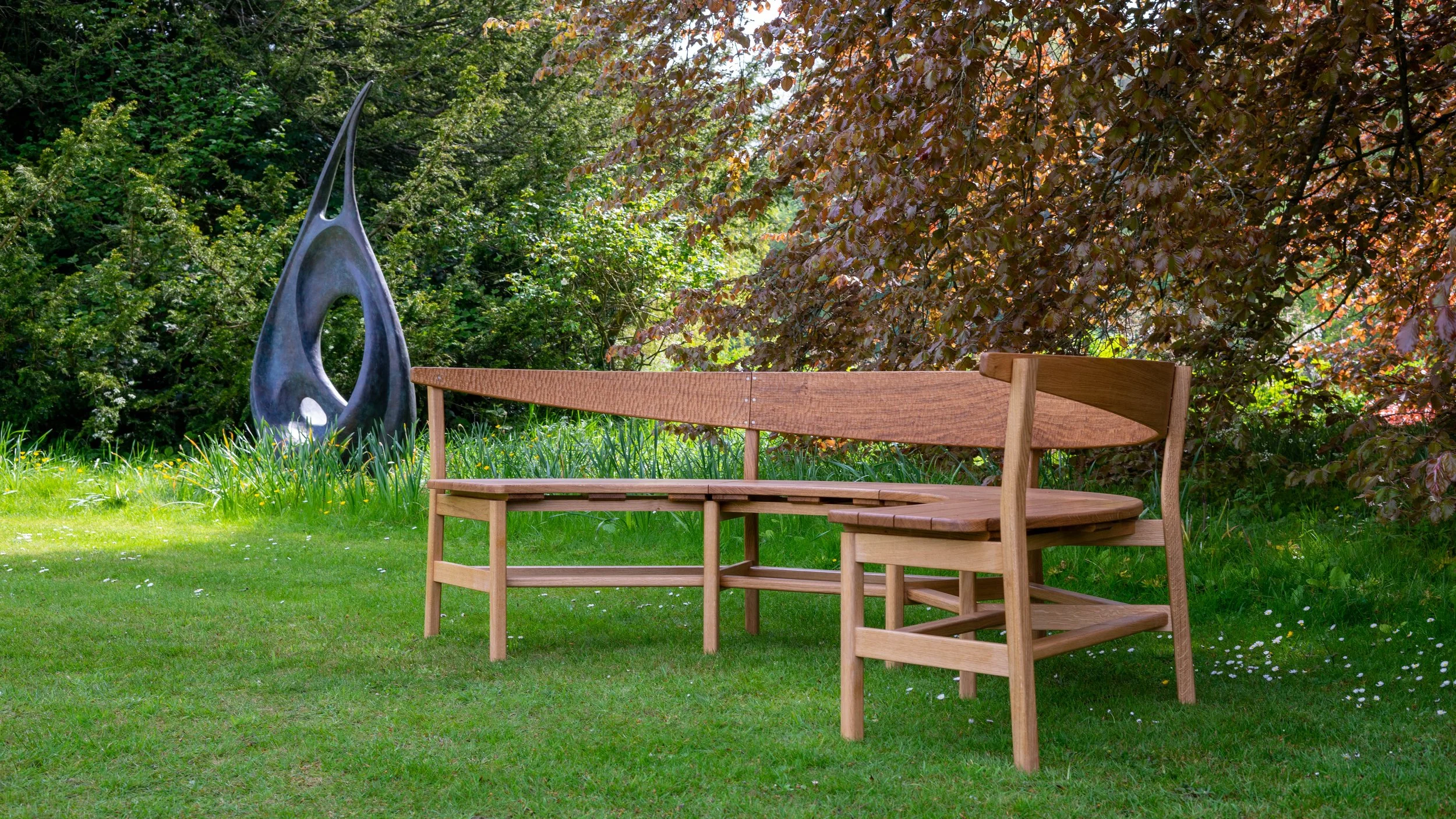 The Coln bench, a large steambent garden bench in solid oak.