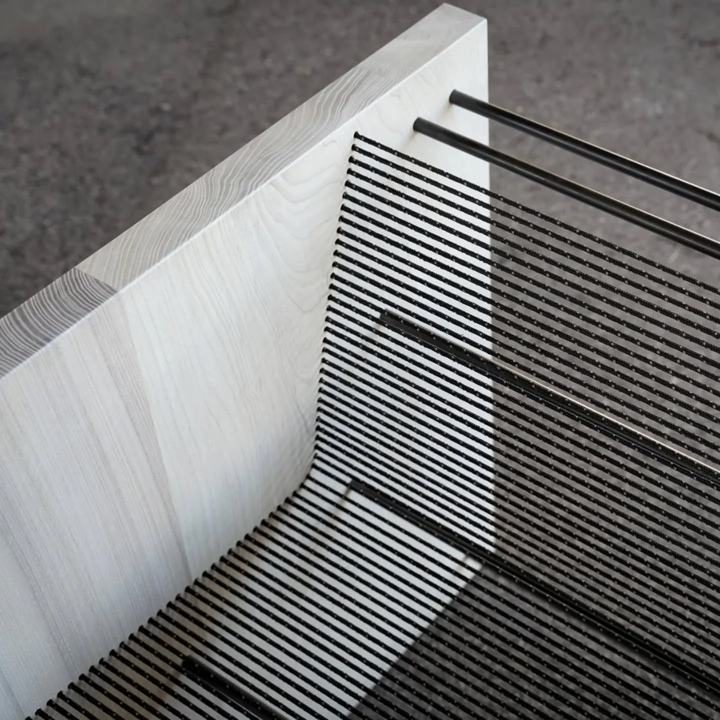 Detail shots of the Stinson

With this design we pushed for maximum contrast between the chunky, textured slab sides and the deceptively strong open cord seat and back.

Viewed from the front, set against a dark backdrop, the cord seat and slender eb